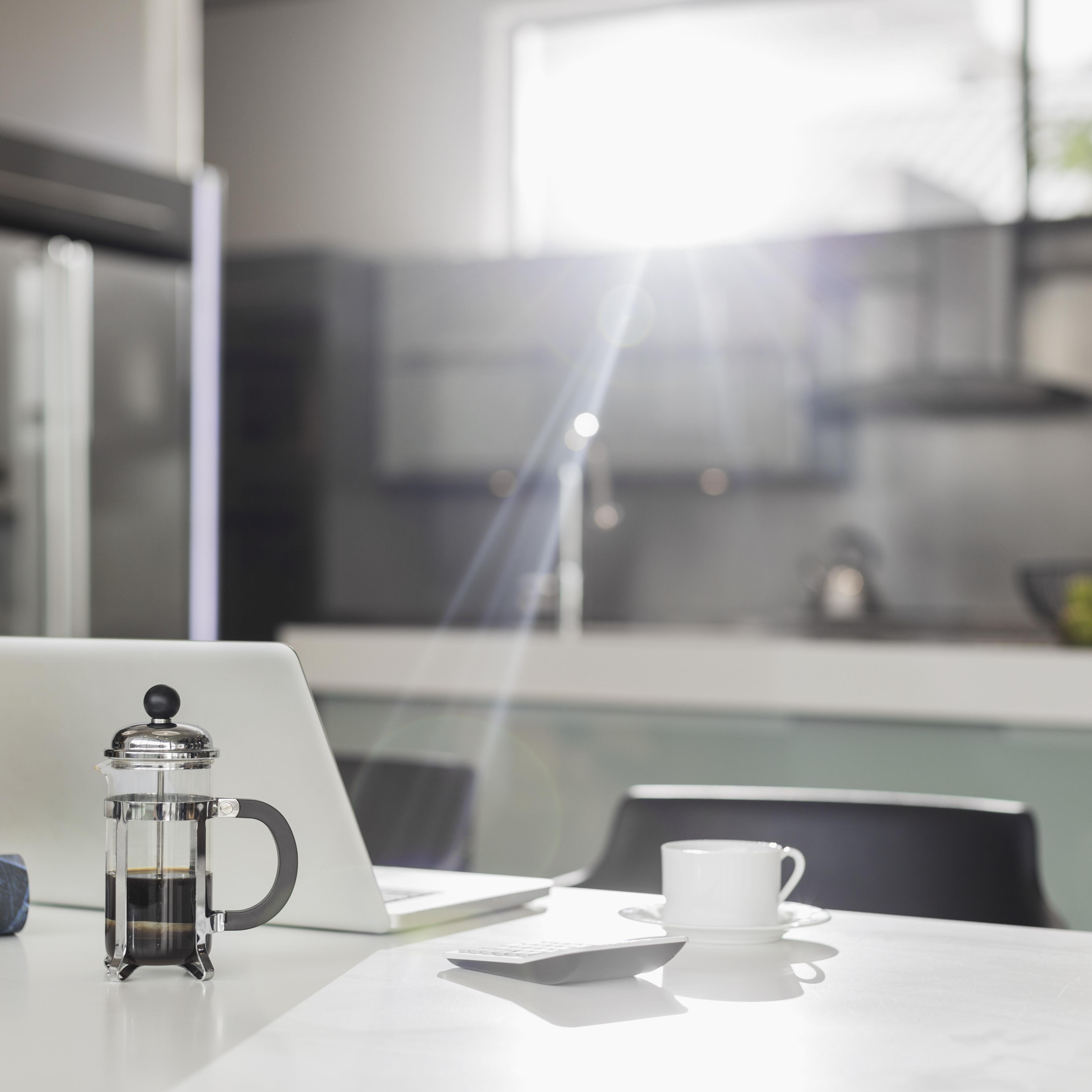 Morning sun shining on laptop in kitchen