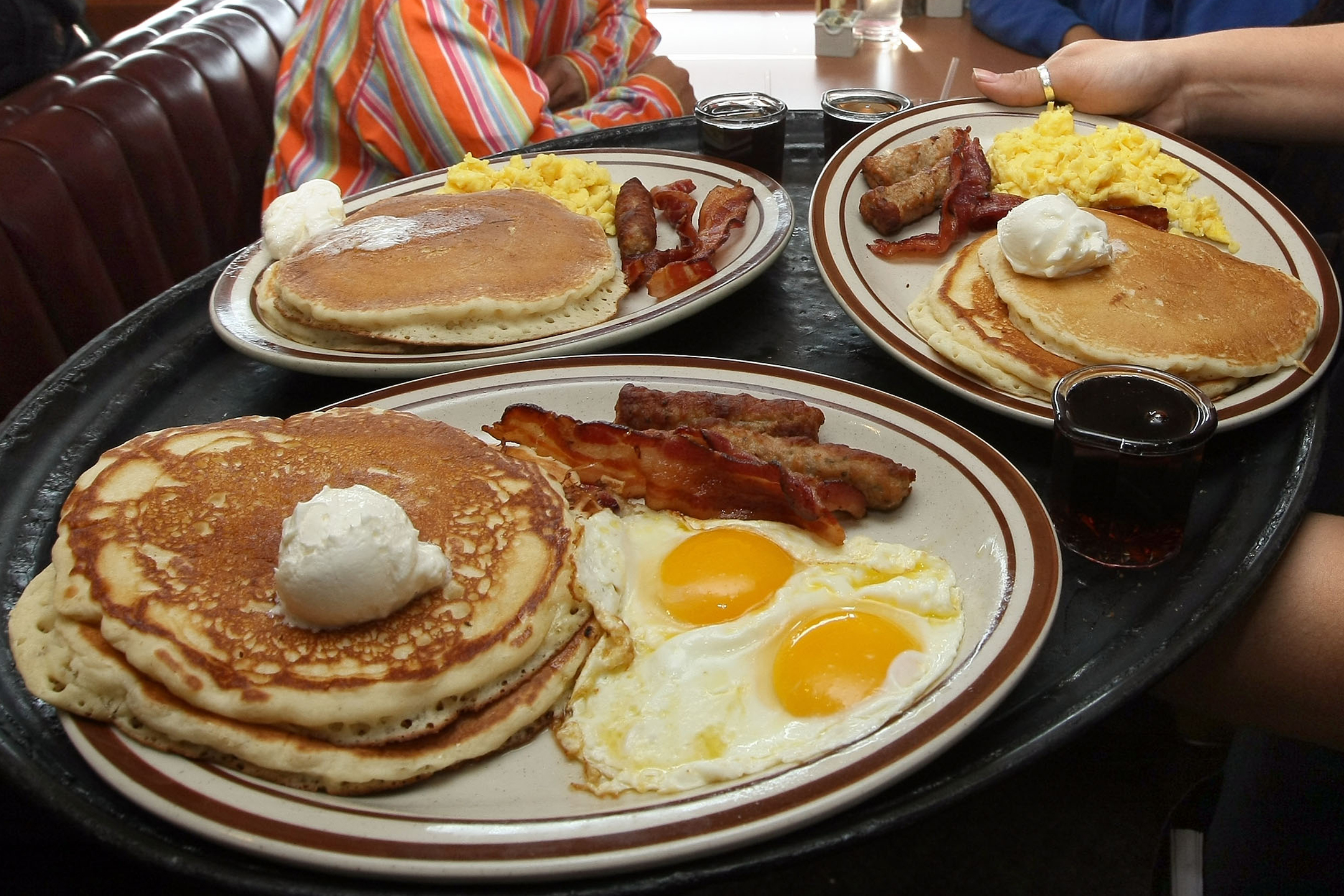 Denny's waitress Tahmina Najemyar delivers free Grand Slam breakfasts to customers on February 3, 2009 in Emeryville, California.