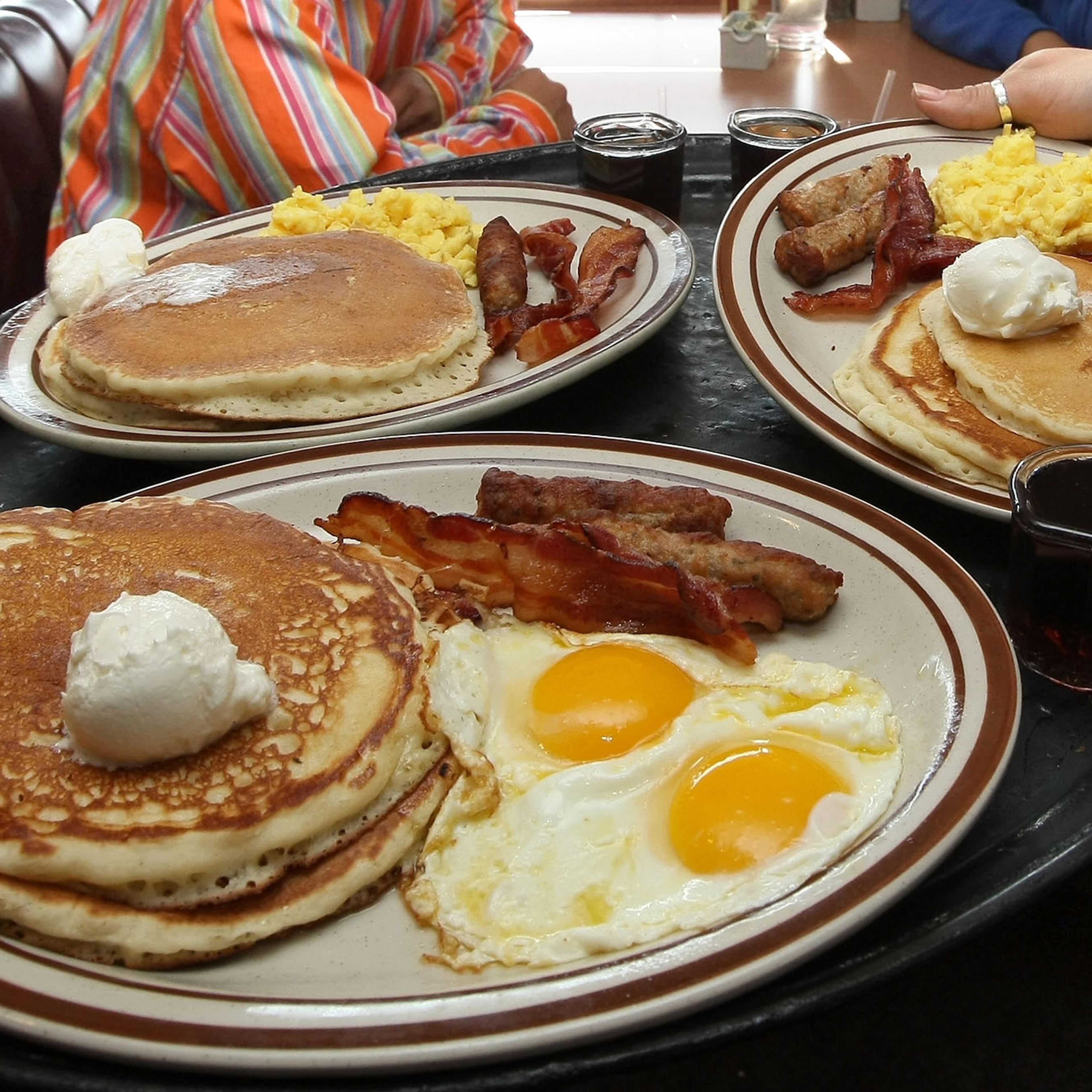 Denny's waitress Tahmina Najemyar delivers free Grand Slam breakfasts to customers on February 3, 2009 in Emeryville, California.