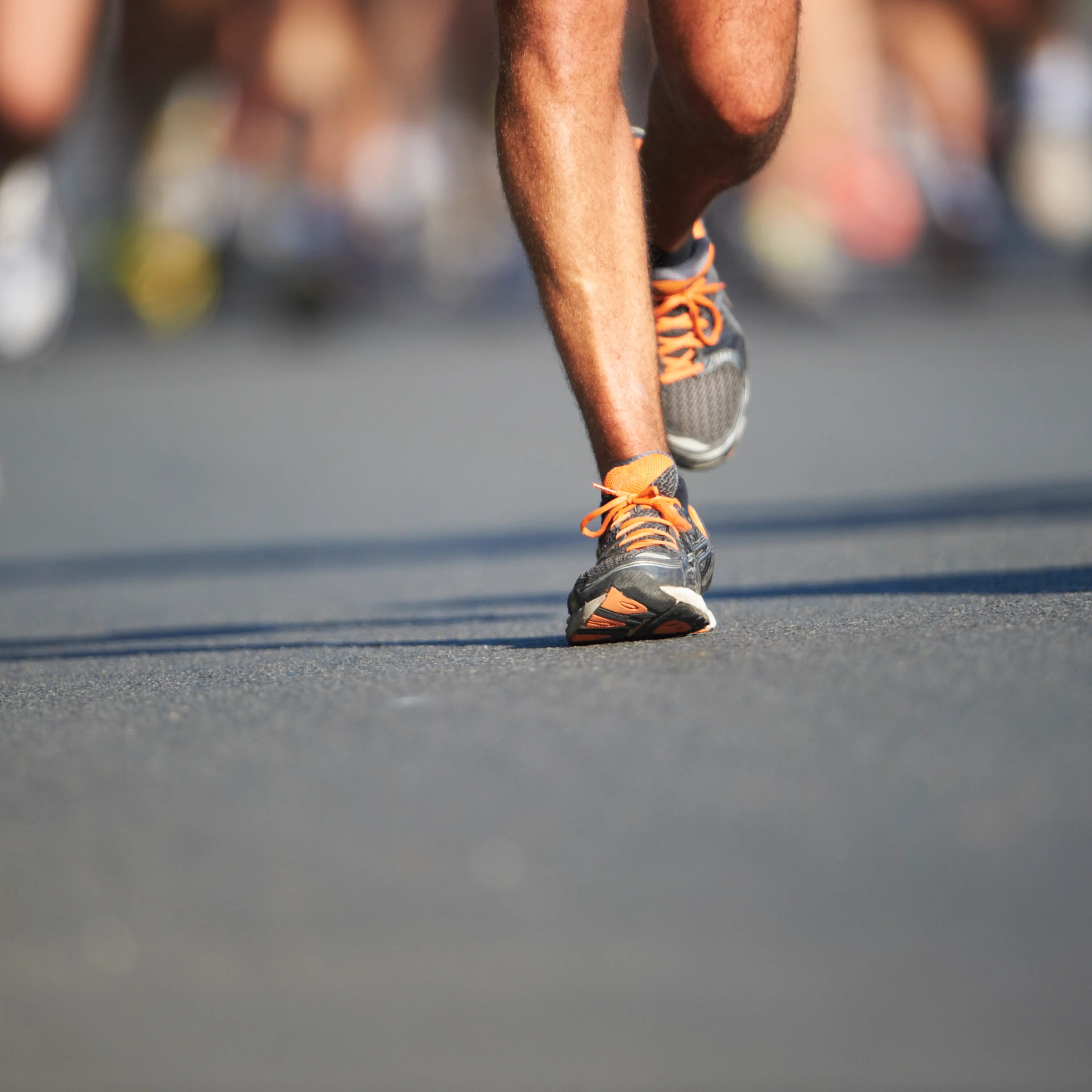 Legs and feet of joggers, running a marathon