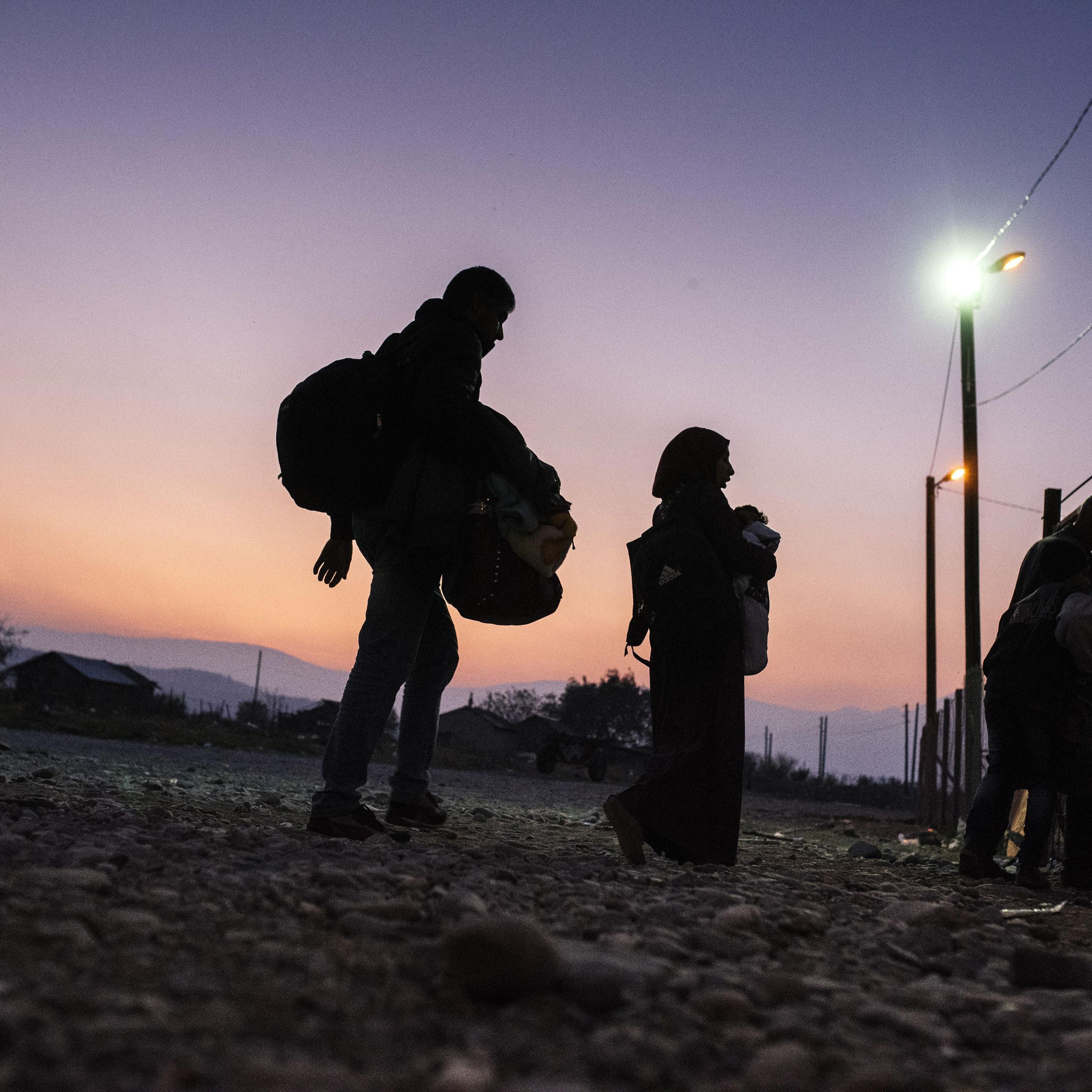 Migrants and refugees enter a registration camp after crossing the Greek-Macedonian border near Gevgelija, Macedonia on Nov. 17, 2015.
