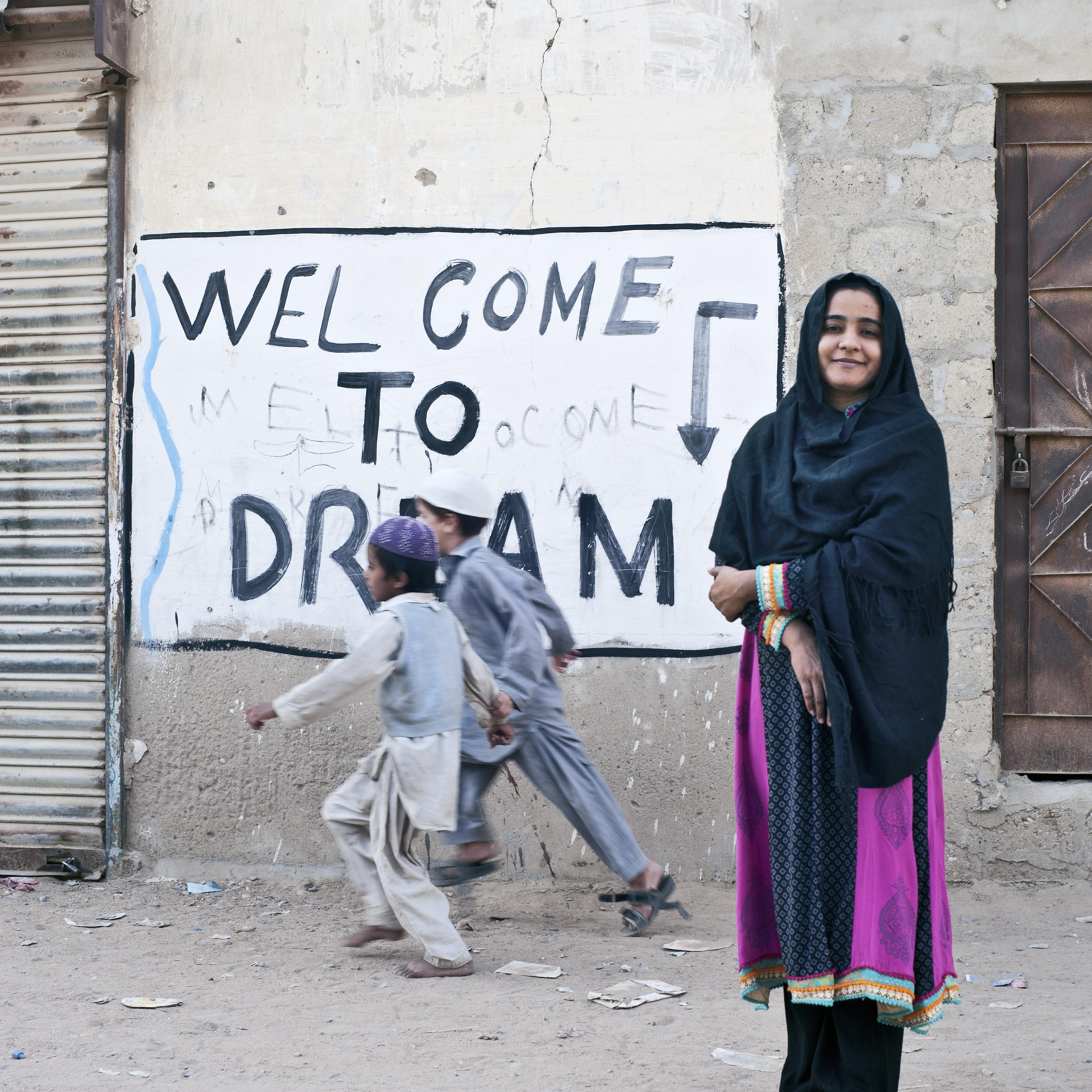 Bachal pauses outside her school in the settlement of Moach Goth, where she lives