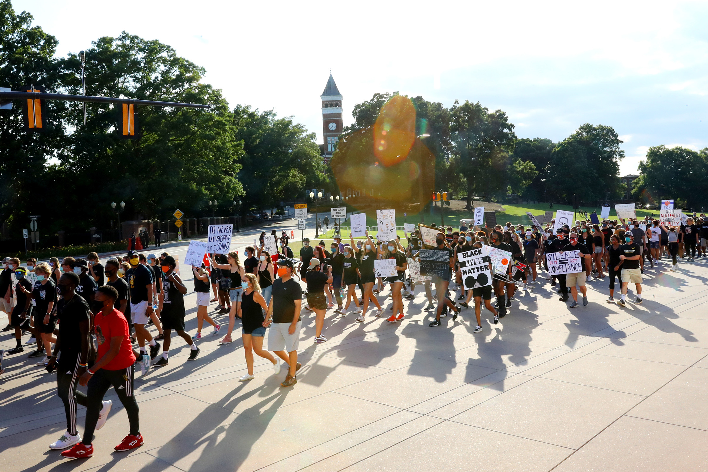 Clemson University football players lead a "March for Change" protest past Tillman Hall on June 13 in Clemson, South Carolina. The Clemson University Board of Trustees voted to strip "Calhoun" from their Honors College name and rename Tillman Hall. 
