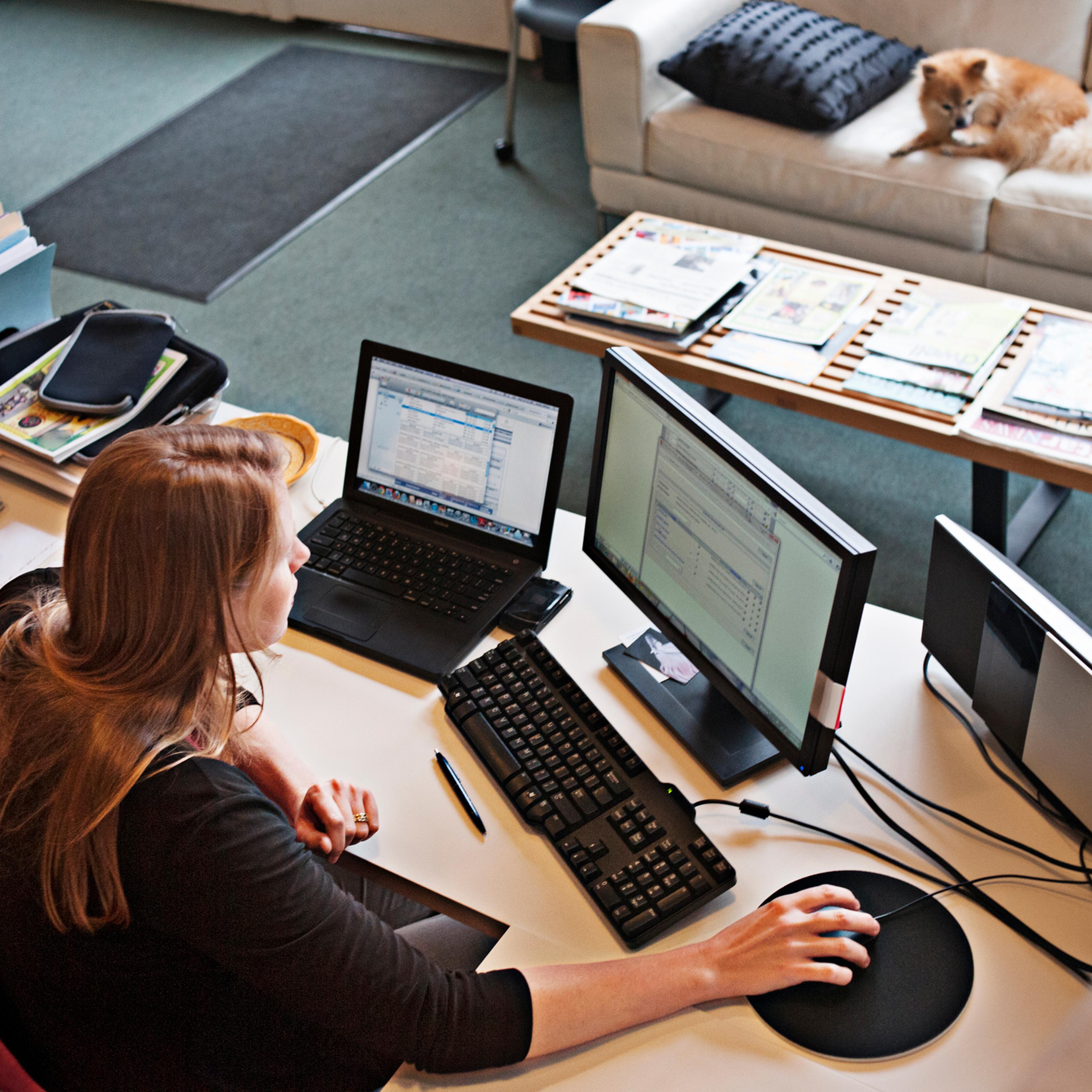 Overview of woman working at office computer