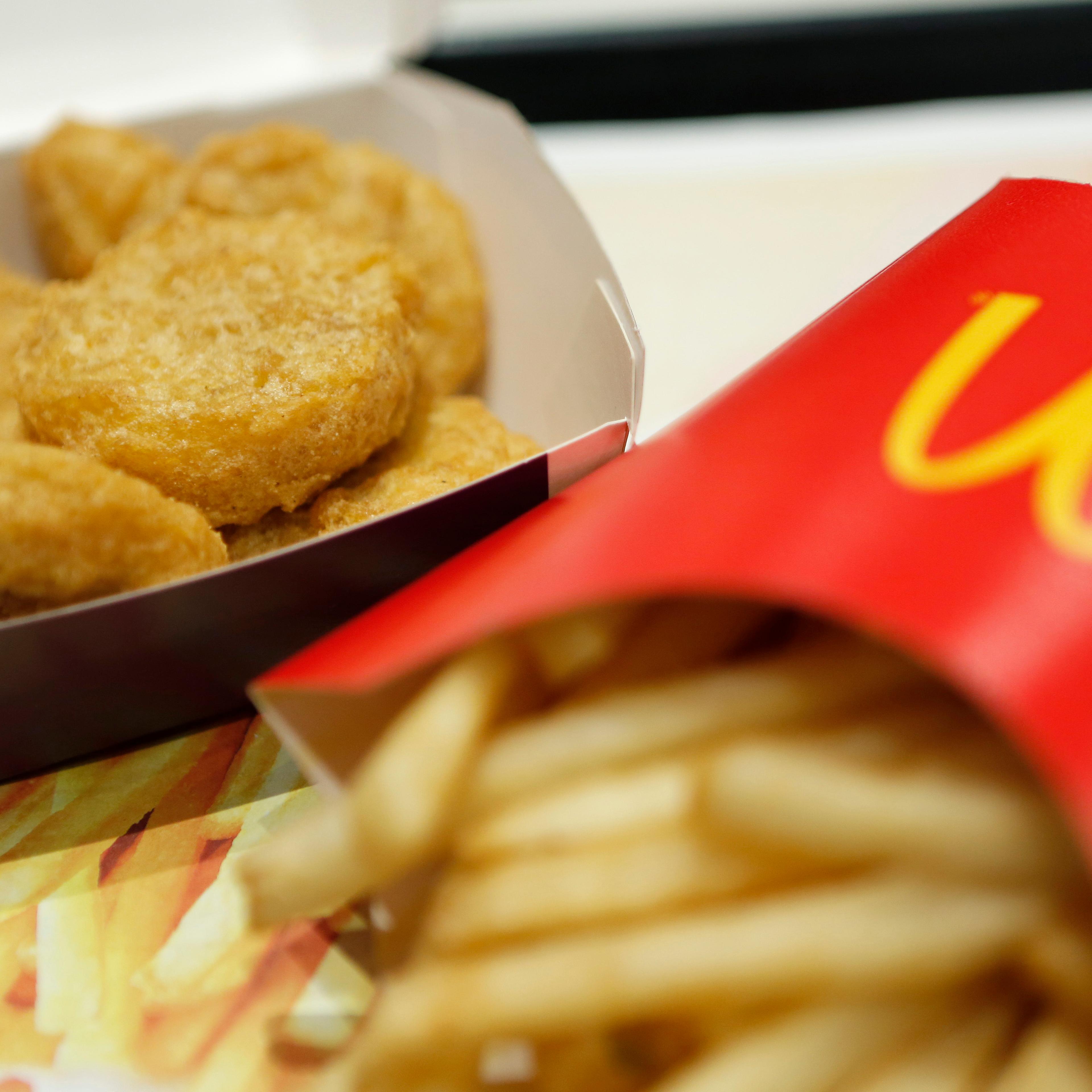 A box of chicken nuggets, left, sits beside a portion of french fries at a McDonald's restaurant, operated by McDonald's Holdings Co. Japan Ltd., in Tokyo, Japan, on Jan.7, 2015.