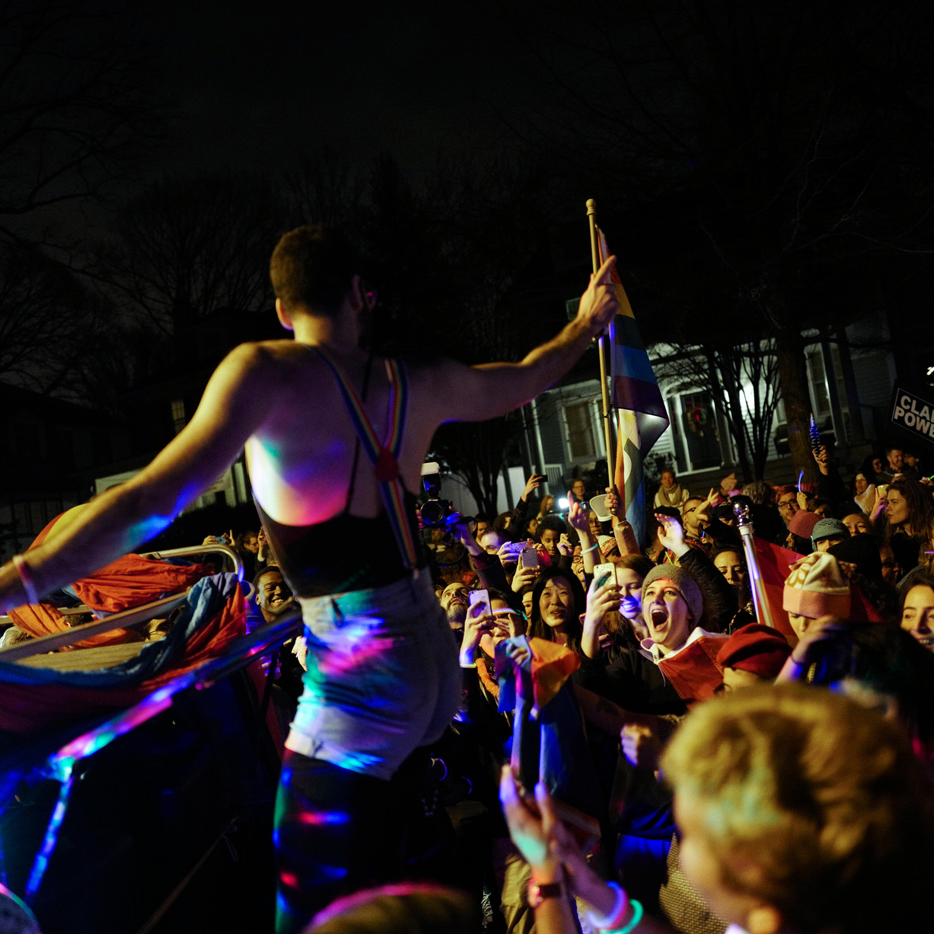A man is cheered at a dance event organized by LGBTQ activist groups DisruptJ20 and WERK for Peace outside Vice President-Elect Mike Pence's temporary residence in Chevy Chase, Md., on Jan. 18, 2017. The protest targeted Pence's record on gay and transge