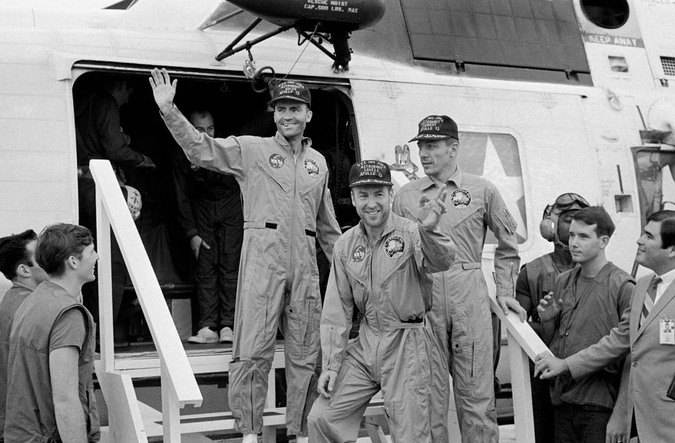 (Left to Right) Fred Haise, Jim Lovell and Jack Swigert, the crew of Apollo 13, step aboard the USS Iwo Jima, prime recovery ship for the mission, following splashdown and recovery operations in the South Pacific Ocean on April 17, 1970.