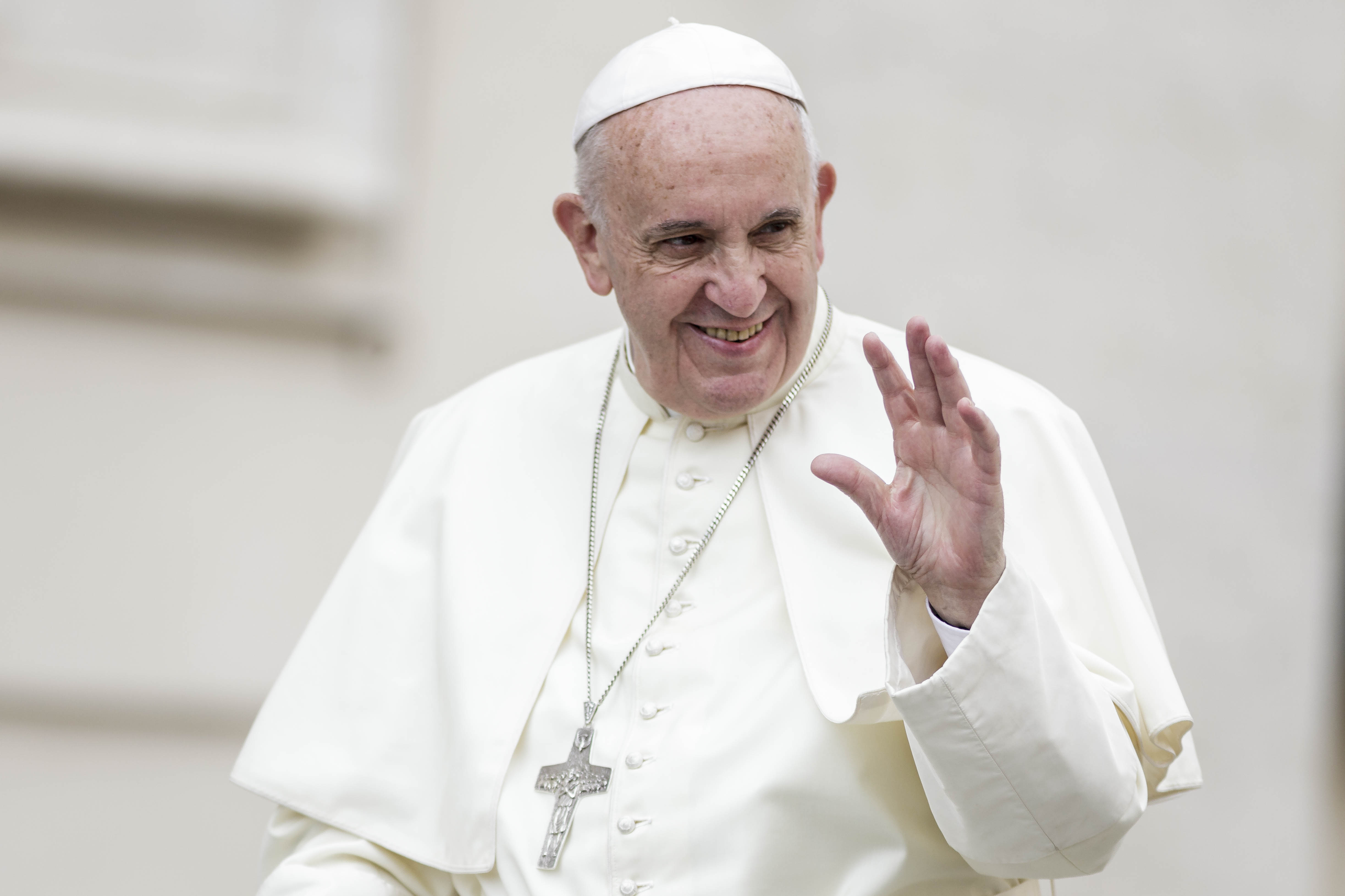 Pope Francis greets the faithful as he attends Weekly