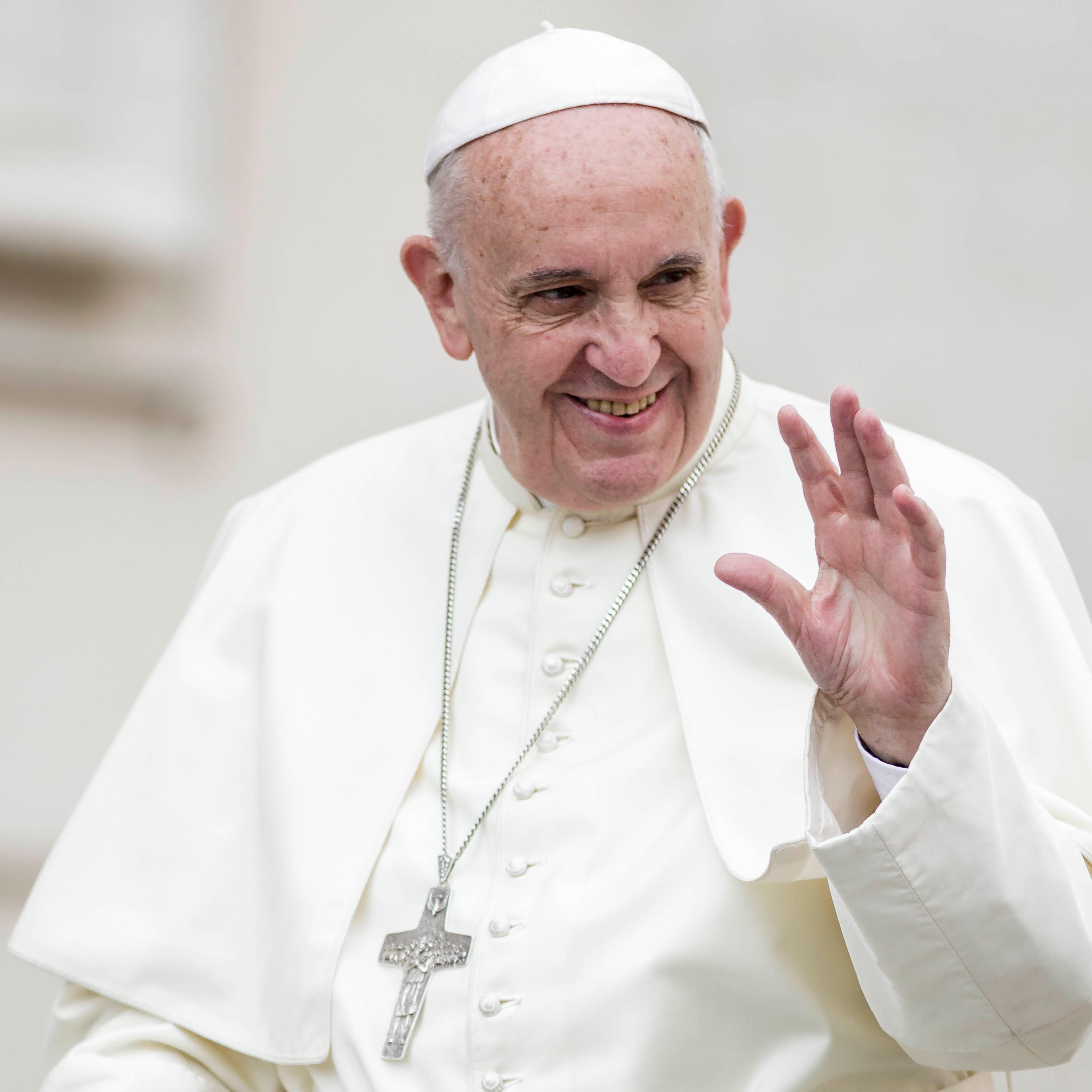Pope Francis greets the faithful as he attends Weekly