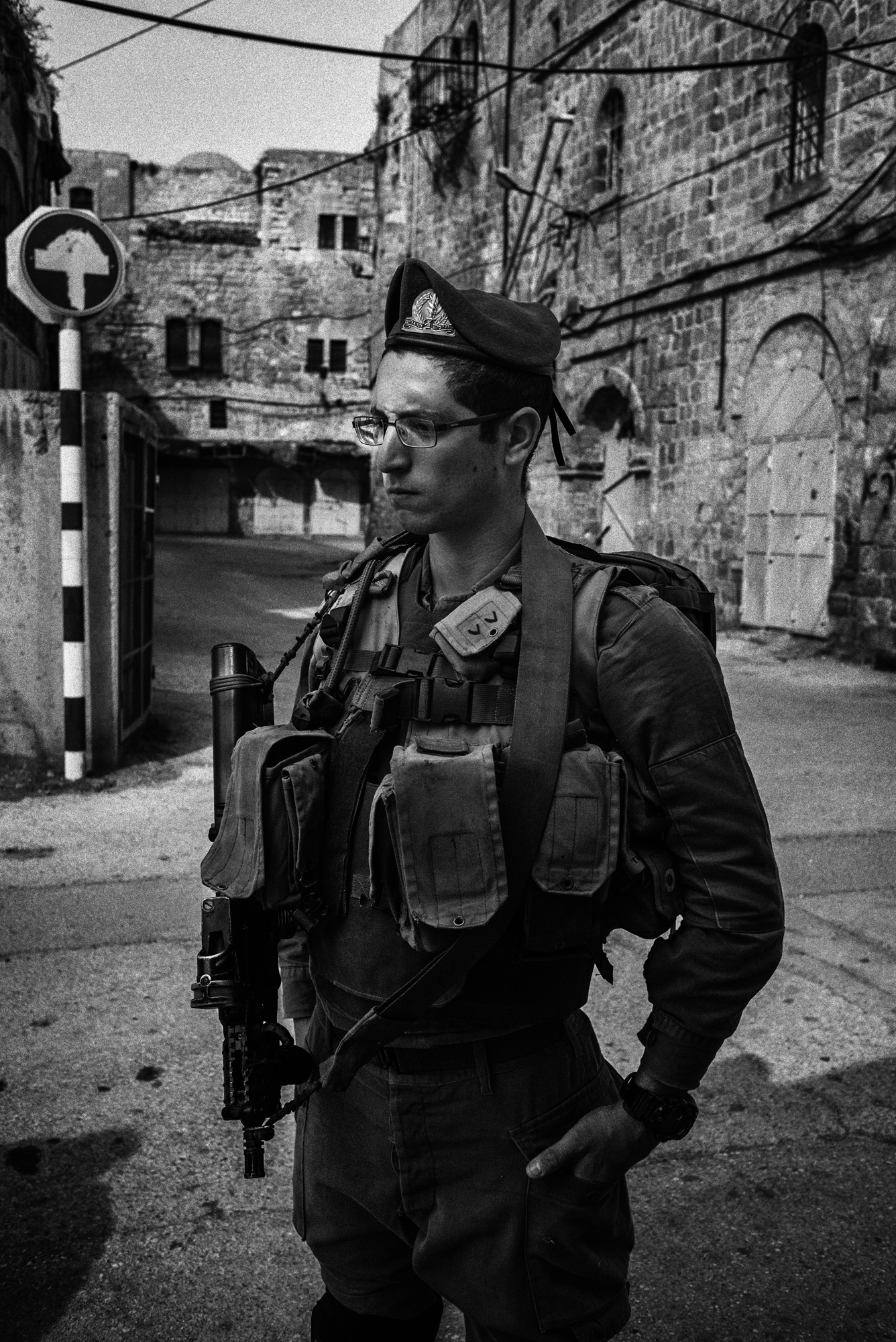 An Israeli soldier stands at a checkpoint in the H2 area of Hebron, November 2015. In late October a Palestinian man was fatally shot here while. Amnesty International said he was retrieving an ID card at the request of a soldier. The rights organization