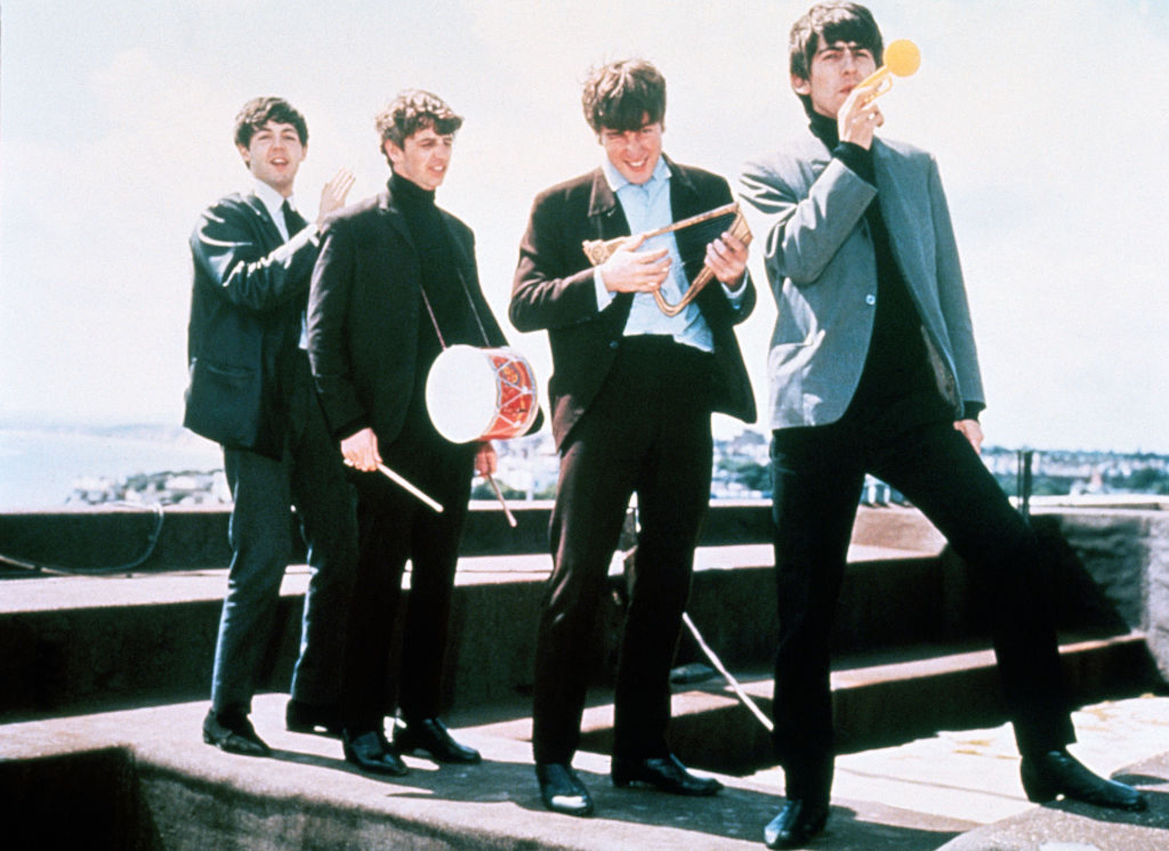 In Dec. 1964, the Beatles clown around on a London rooftop, left to right: Paul McCartney, Ringo Starr, John Lennon, and George Harrison.