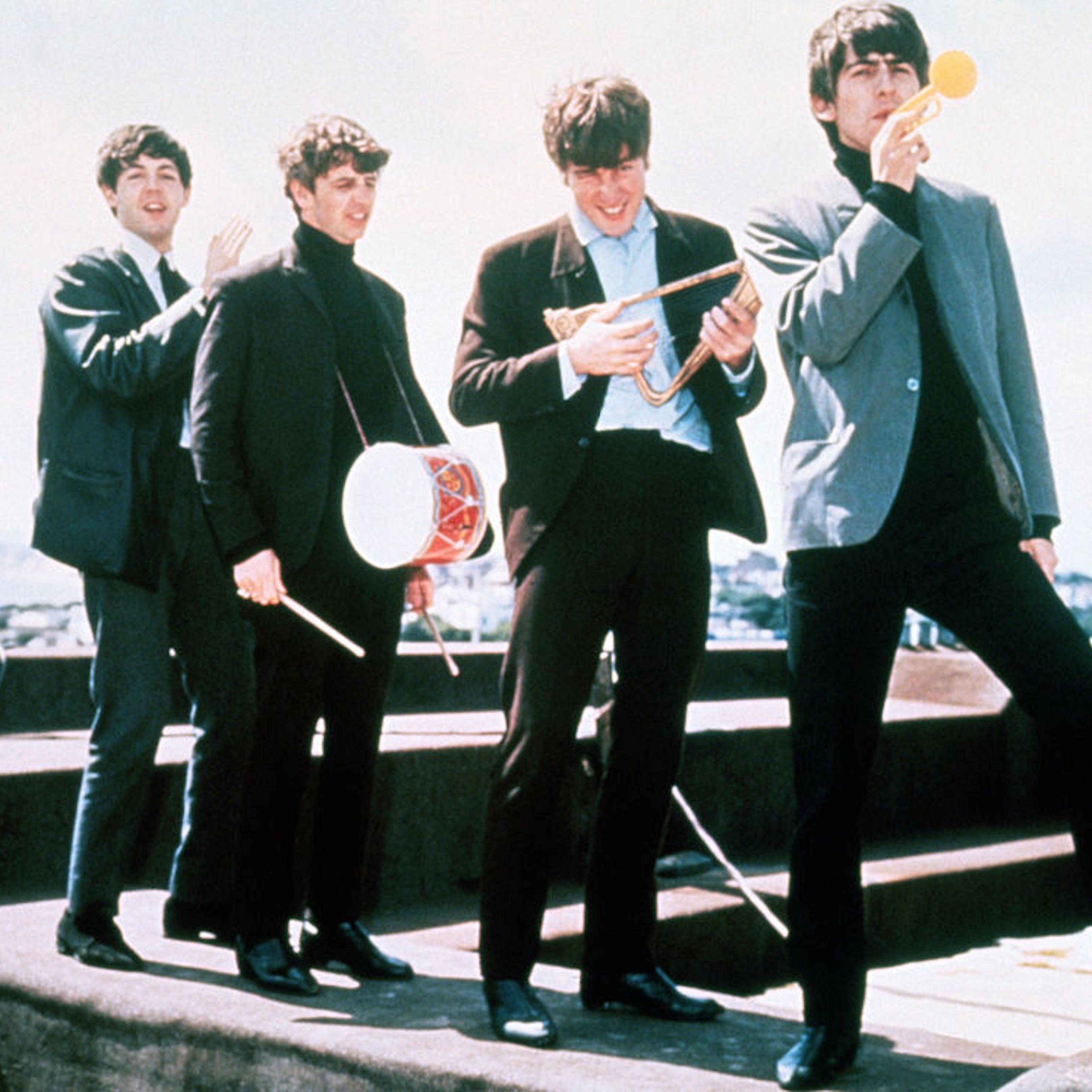 In Dec. 1964, the Beatles clown around on a London rooftop, left to right: Paul McCartney, Ringo Starr, John Lennon, and George Harrison.