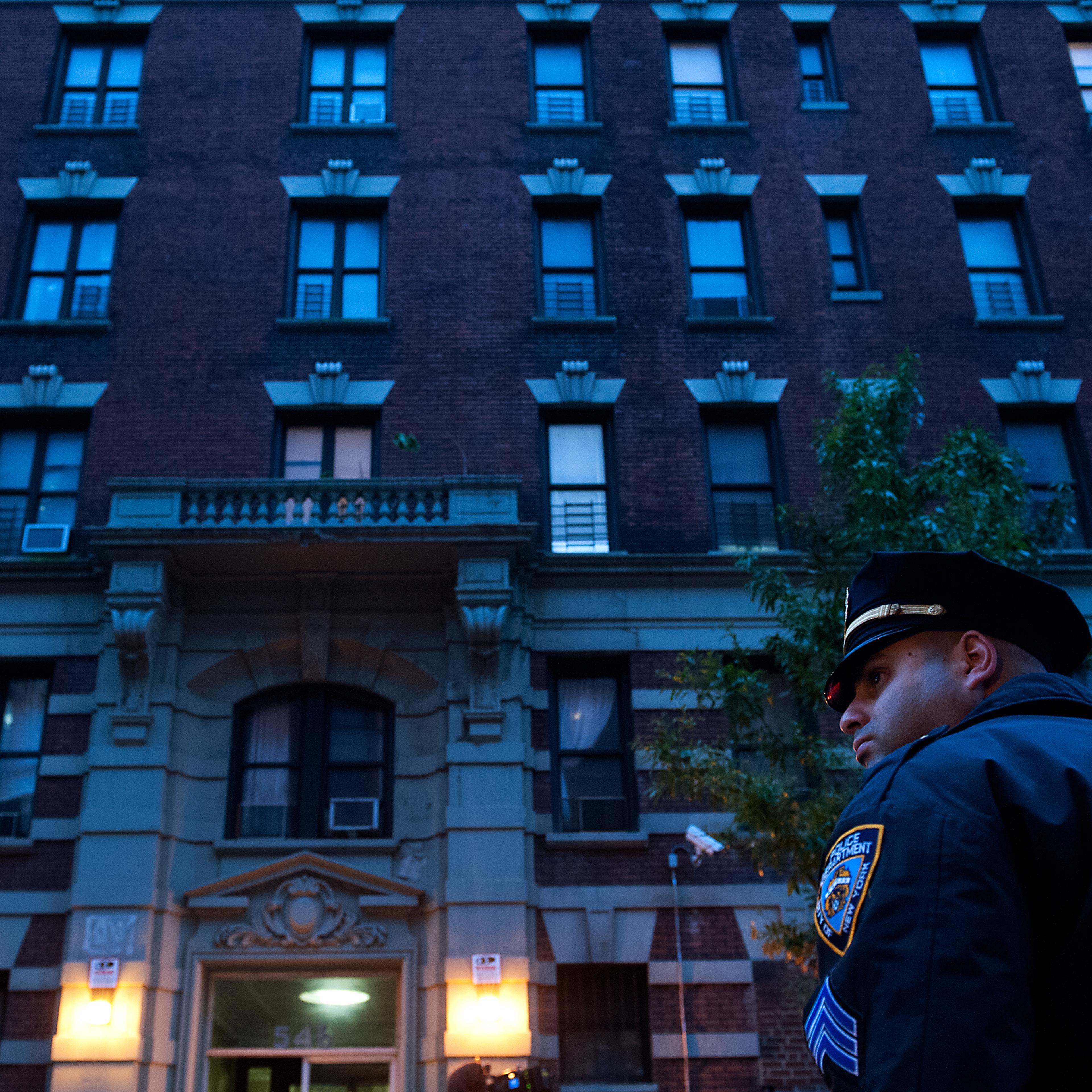 Police officers stand outside 546 W. 147th street, the apartment building of Dr. Craig Spencer on Oct. 23, 2014 in New York City.