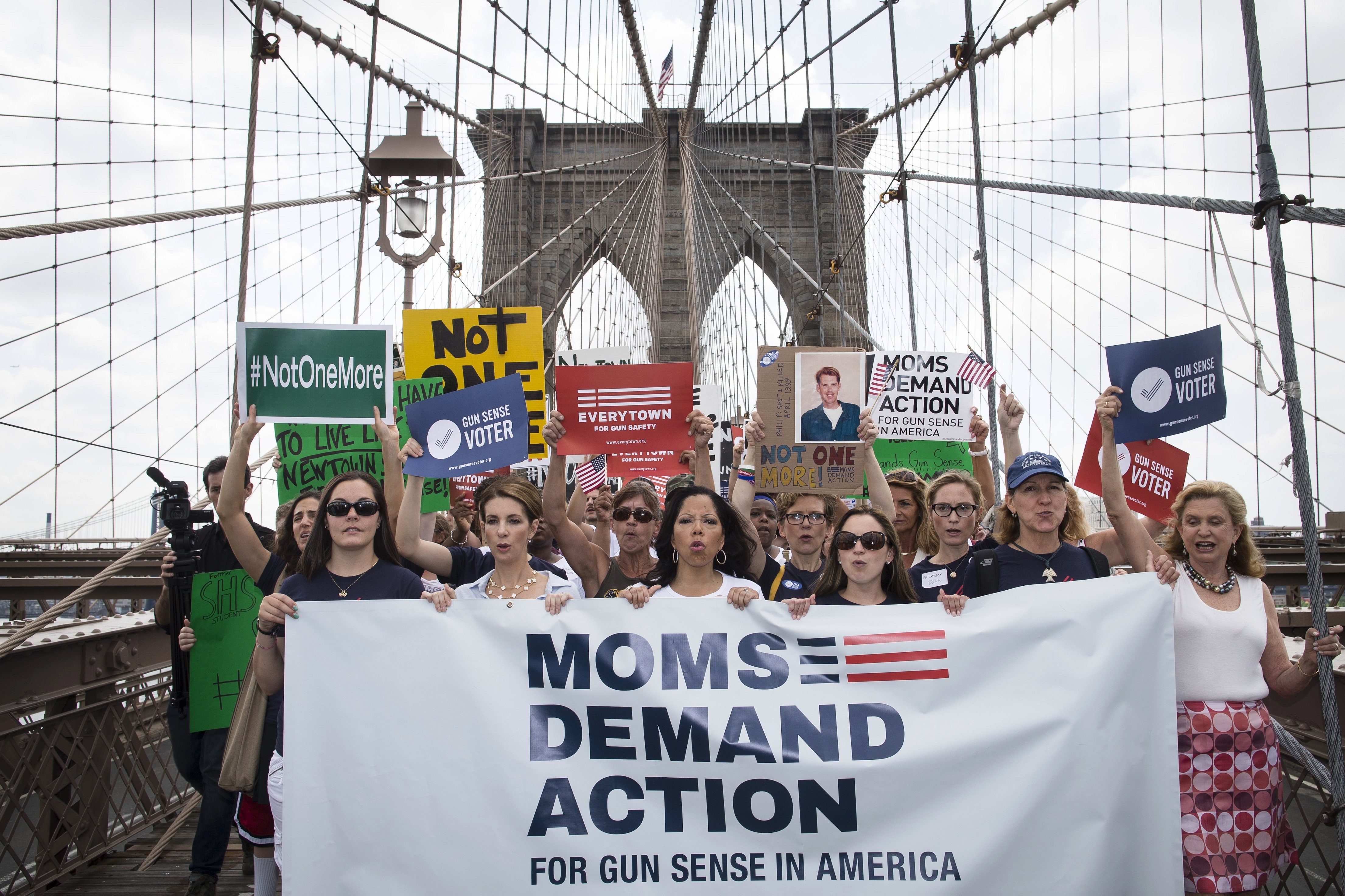 Hundreds of demonstrators march across the Brooklyn Bridge to call for tougher gun control laws, Saturday, June 14, 2014, in New York.