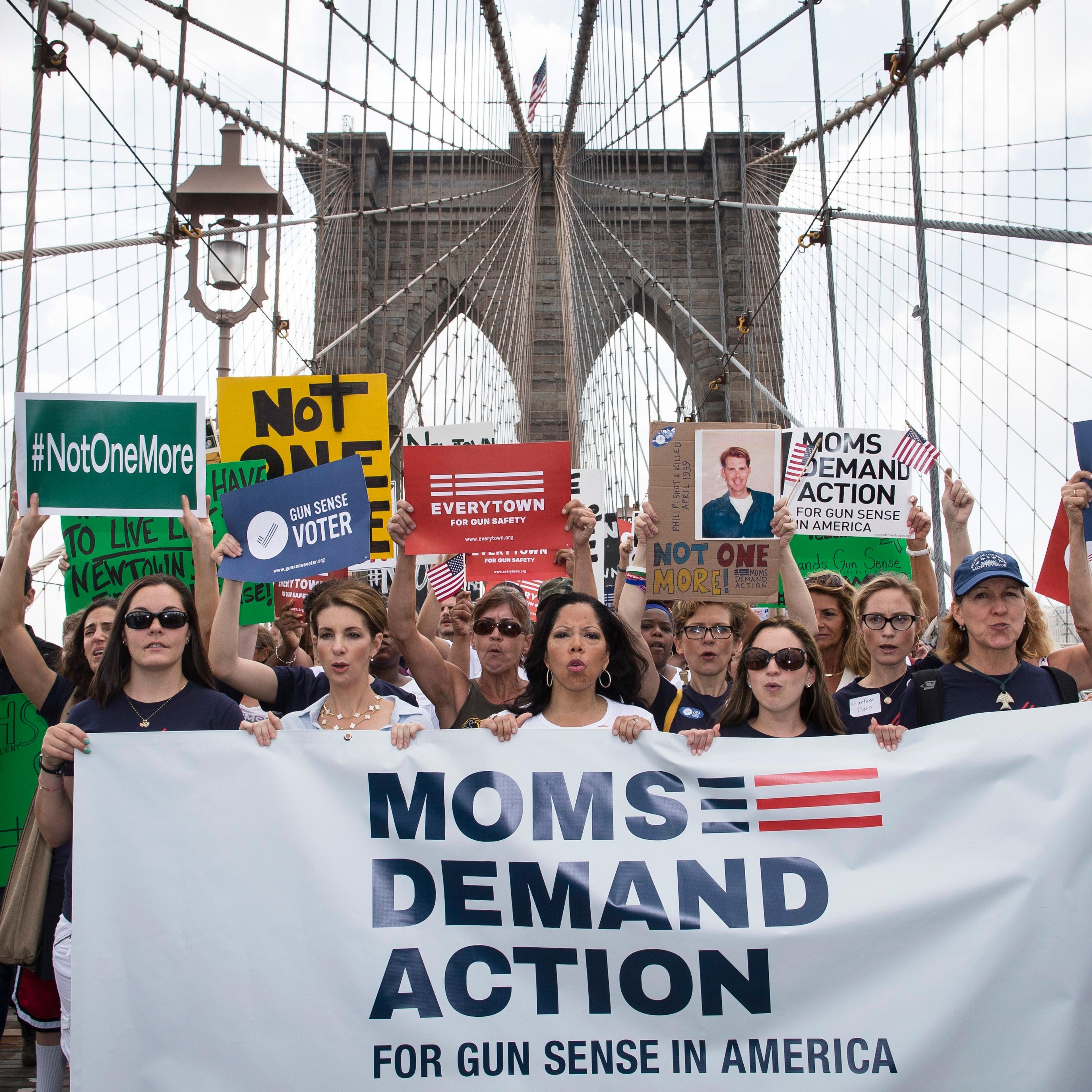 Hundreds of demonstrators march across the Brooklyn Bridge to call for tougher gun control laws, Saturday, June 14, 2014, in New York.