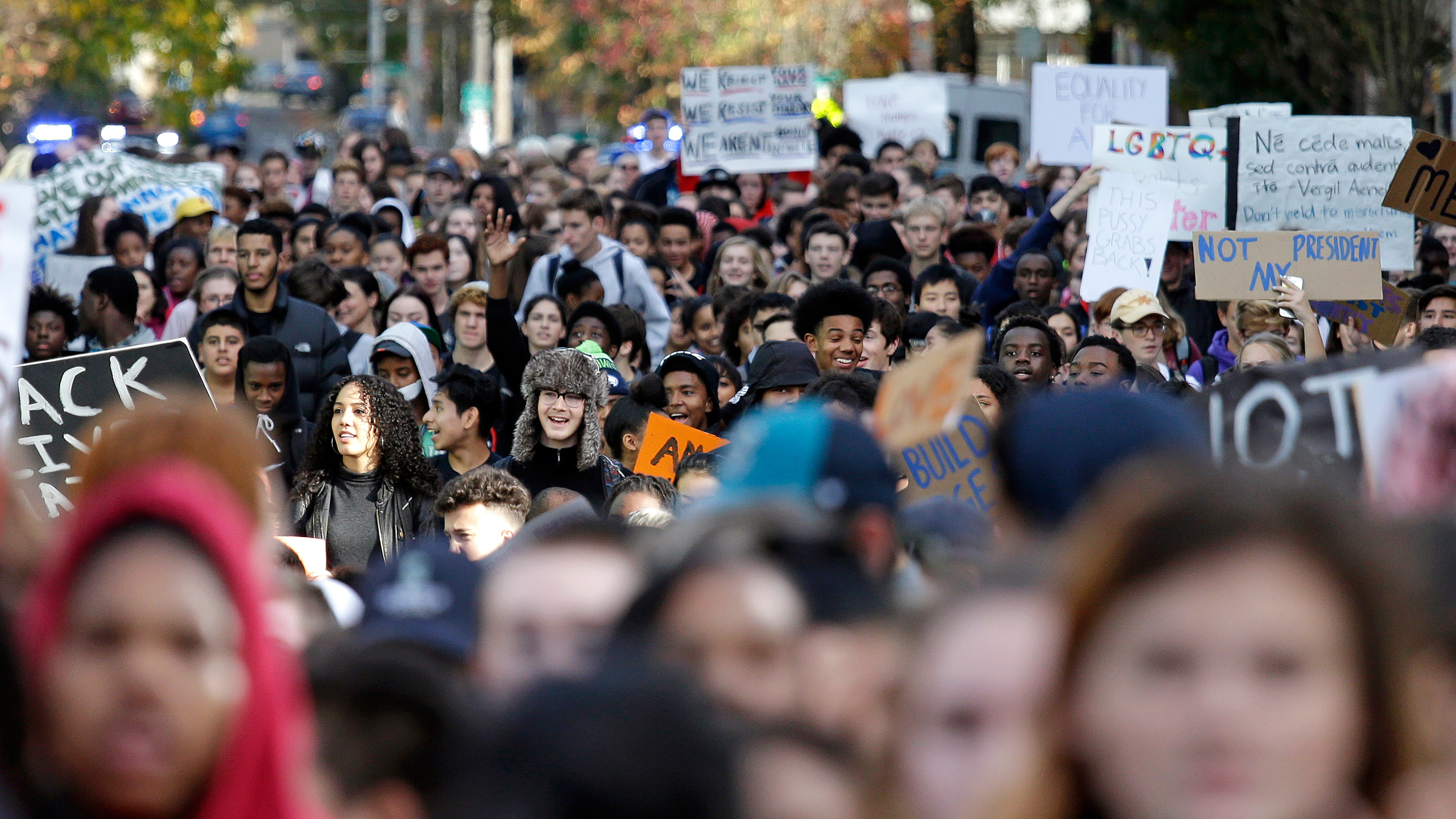 High school students fill a street as they head to join others during a walkout to protest the election of Donald Trump as president, Monday, Nov. 14, 2016, in Seattle. A spokesman with Seattle Public Schools estimates that about 2,300 students from 14 m