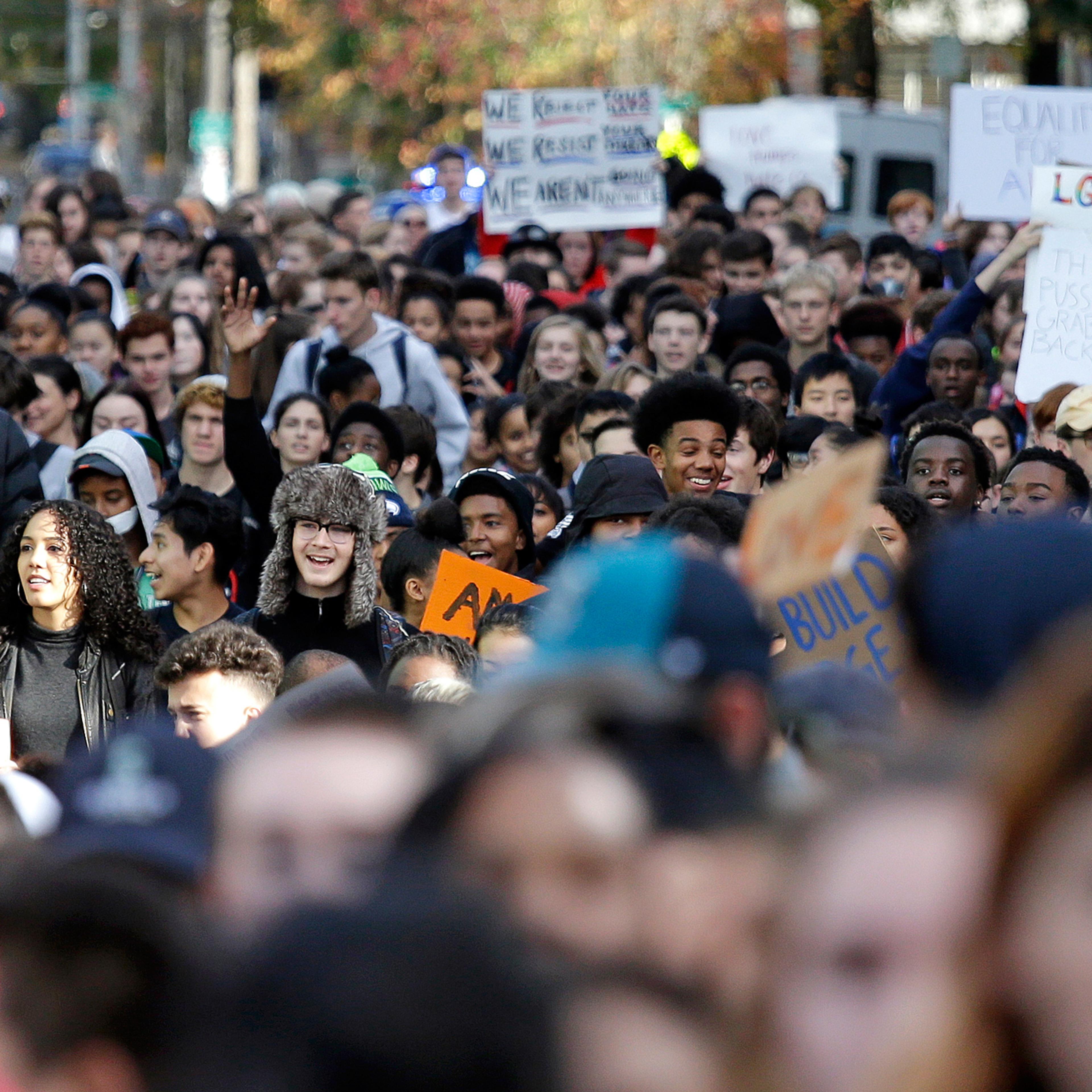 High school students fill a street as they head to join others during a walkout to protest the election of Donald Trump as president, Monday, Nov. 14, 2016, in Seattle. A spokesman with Seattle Public Schools estimates that about 2,300 students from 14 m