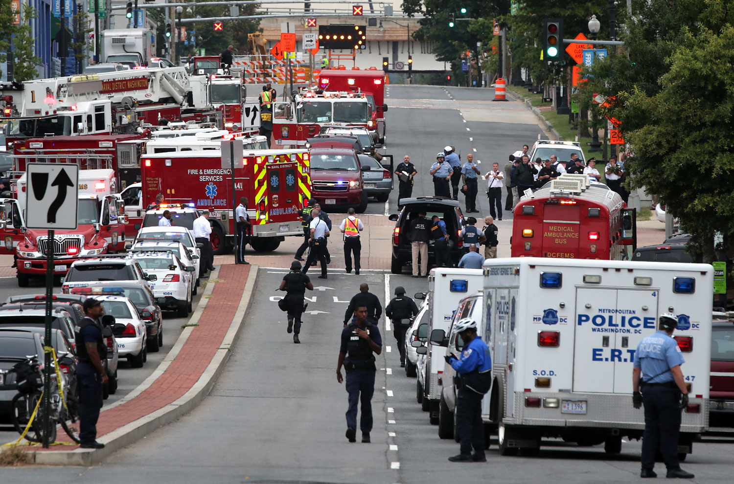 Emergency vehicles and law enforcement personnel respond to a shooting at an entrance to the Washington Navy Yard, Sept. 16, 2013 in Washington, DC.