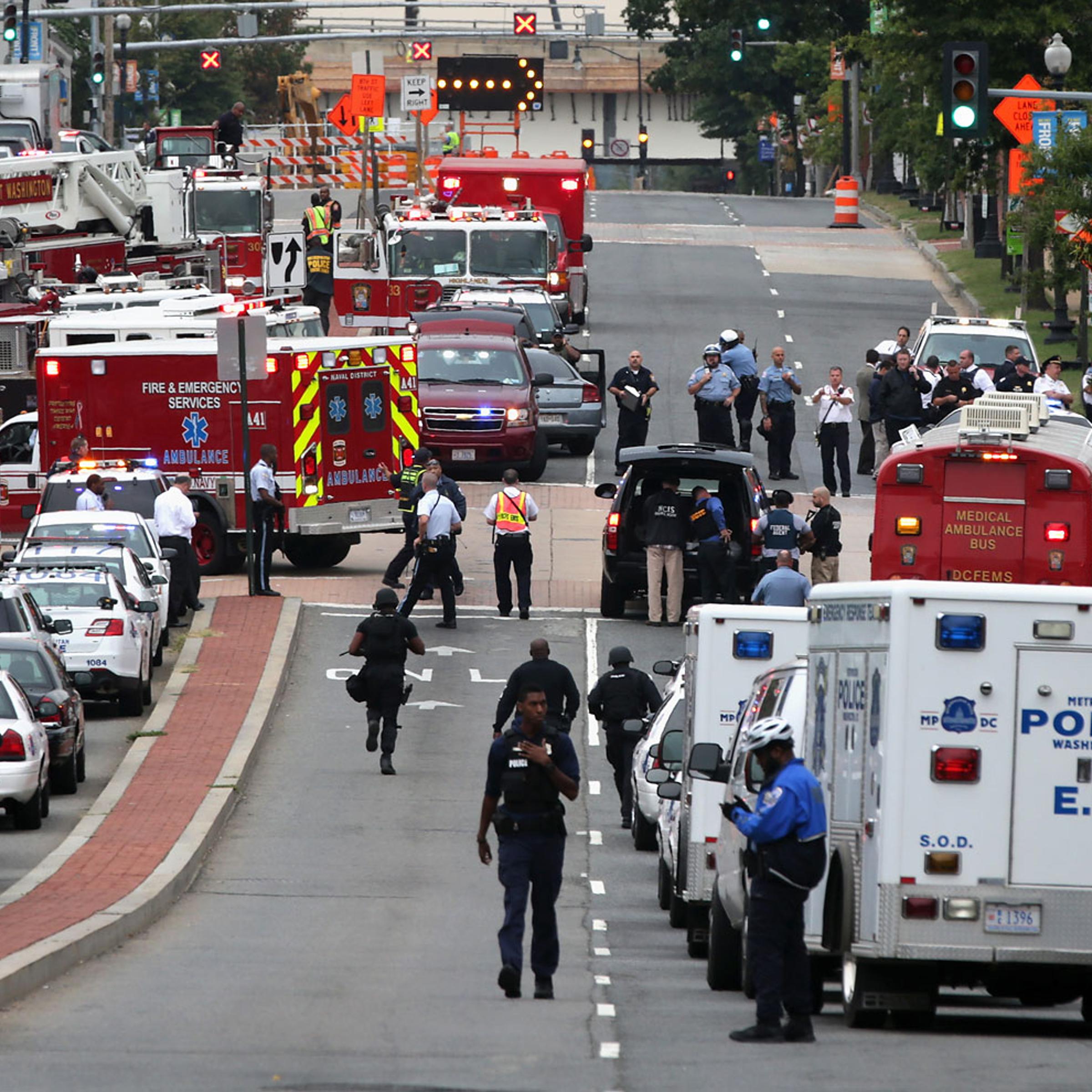 Emergency vehicles and law enforcement personnel respond to a shooting at an entrance to the Washington Navy Yard, Sept. 16, 2013 in Washington, DC.