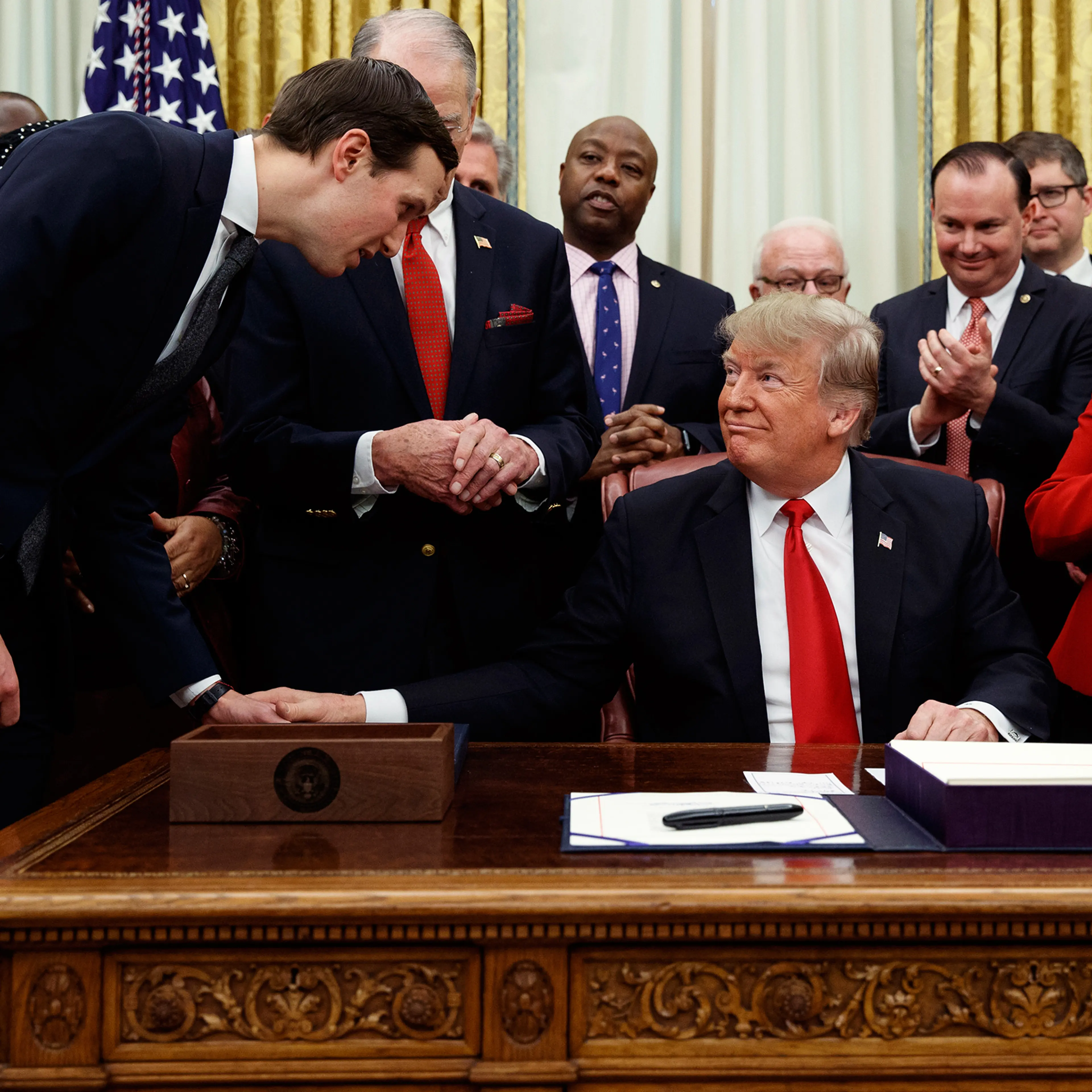White House senior adviser Jared Kushner talks with President Donald Trump during a signing ceremony for criminal justice reform legislation in the Oval Office of the White House, Dec. 21, 2018.