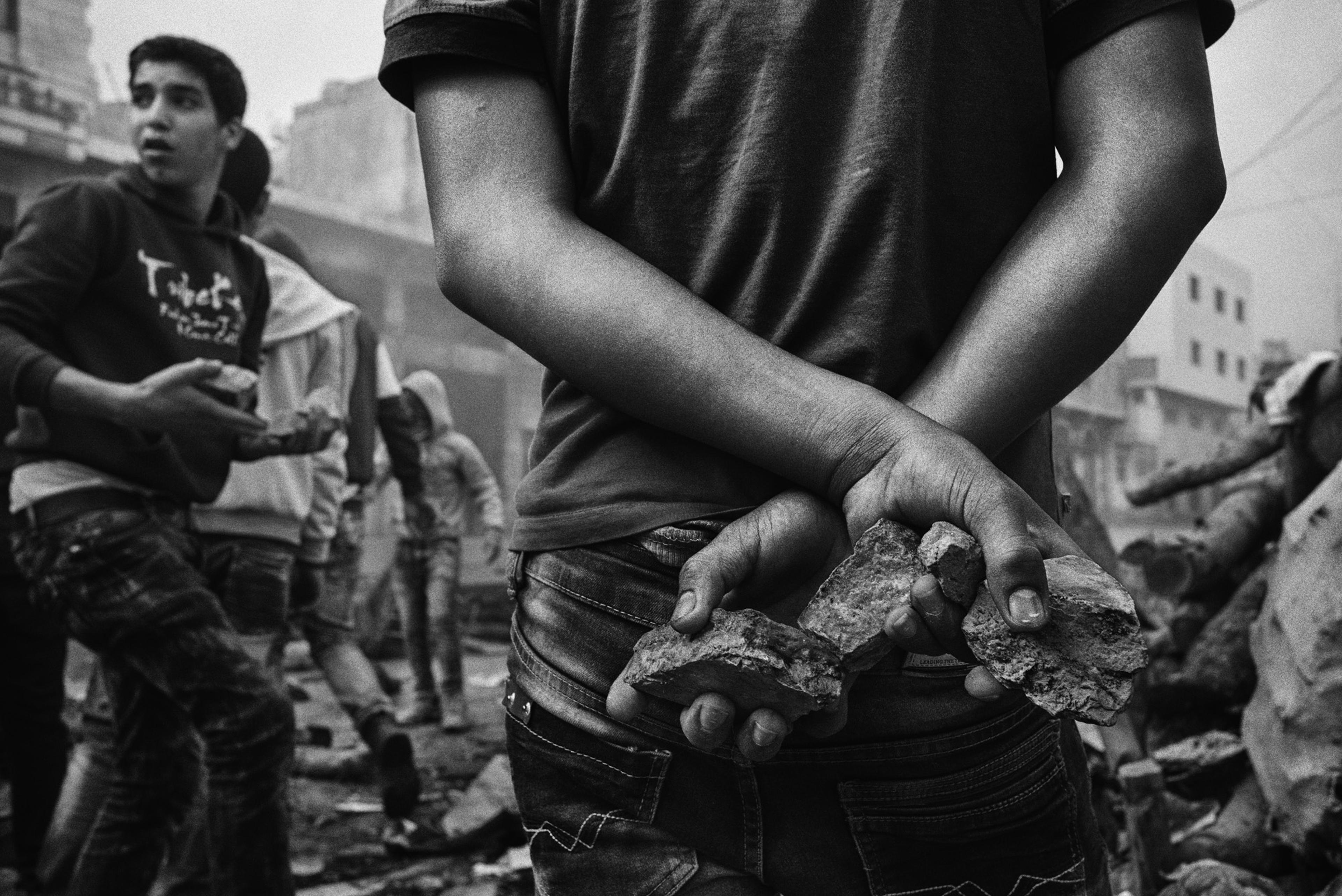 Young Palestinian stone-throwers gather near a checkpoint that leads into the Tel Rumeida neighborhood of Hebron, November 2015.