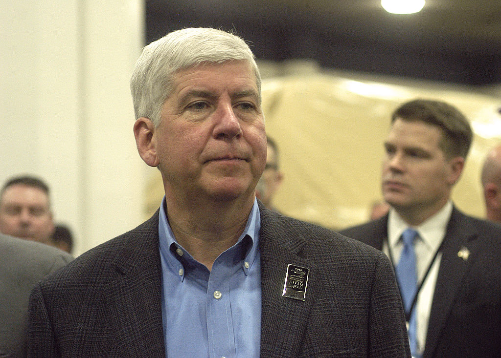 Michigan Gov. Rick Snyder tours the show floor on Tuesday during the press preview for the 2016 North American International Auto Show at Cobo Hall on January 12, 2016 in Detroit, Michigan.
