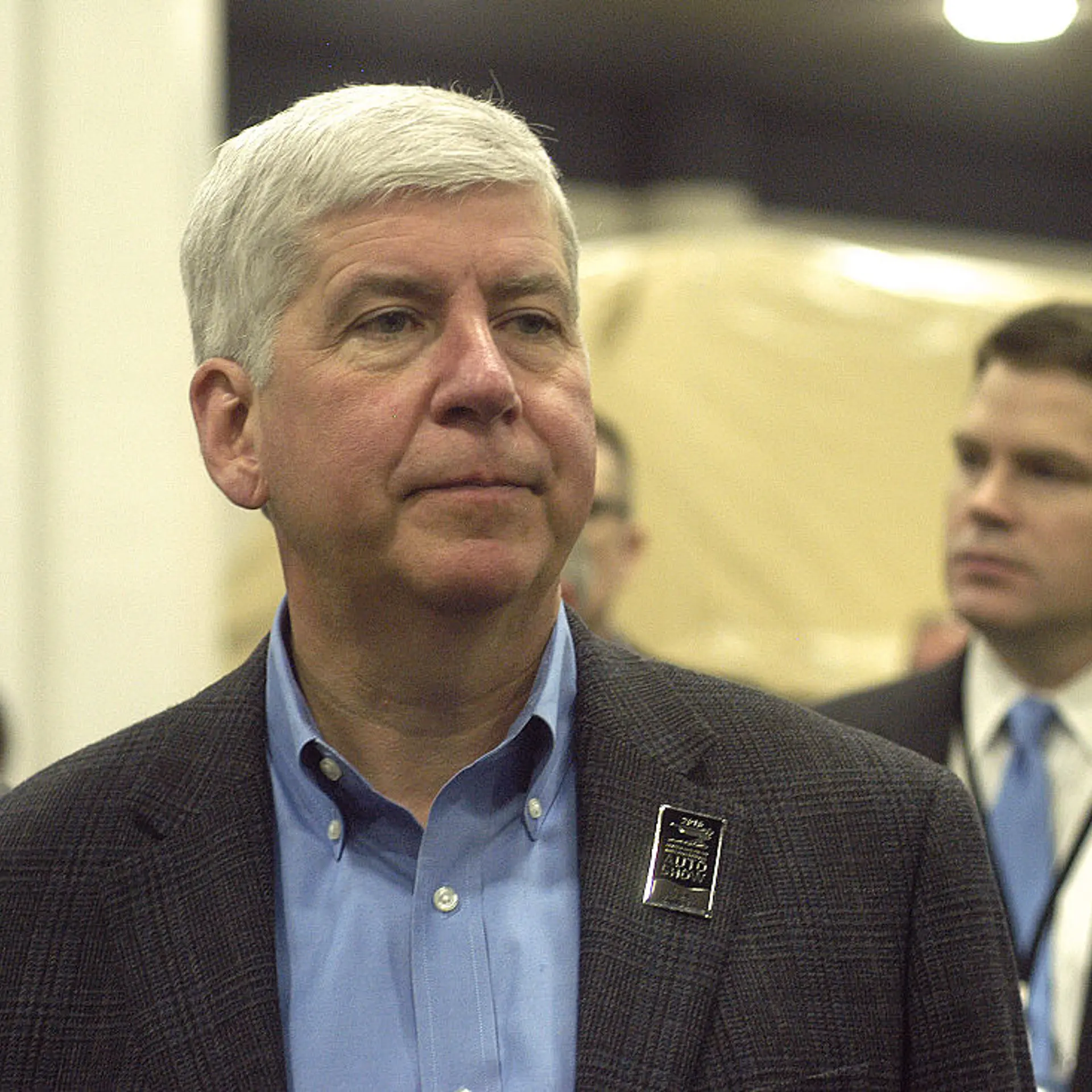 Michigan Gov. Rick Snyder tours the show floor on Tuesday during the press preview for the 2016 North American International Auto Show at Cobo Hall on January 12, 2016 in Detroit, Michigan.