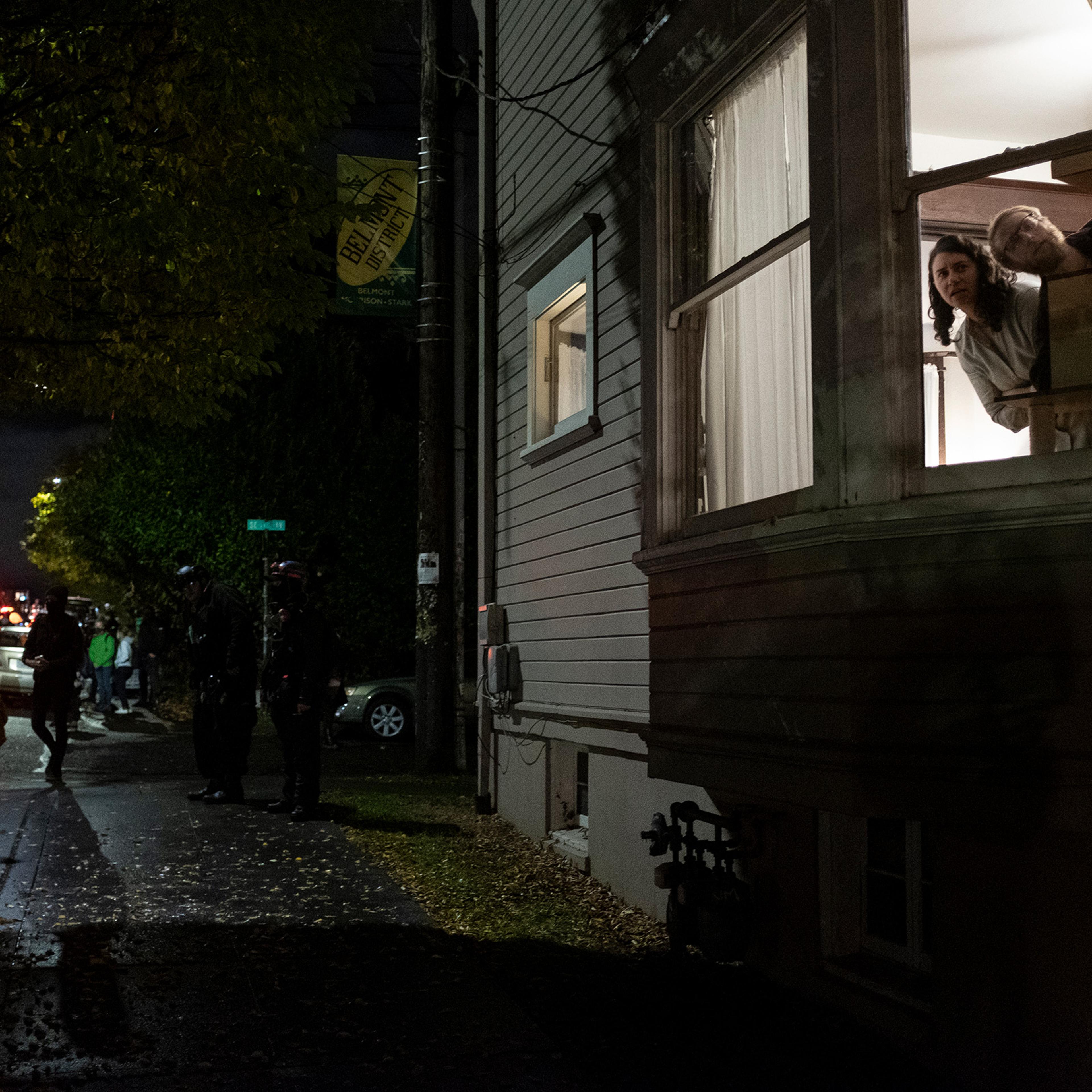 Residents watch a Black Lives Matter protest march through their neighborhood on election day in Portland, Ore., Nov. 3, 2020.