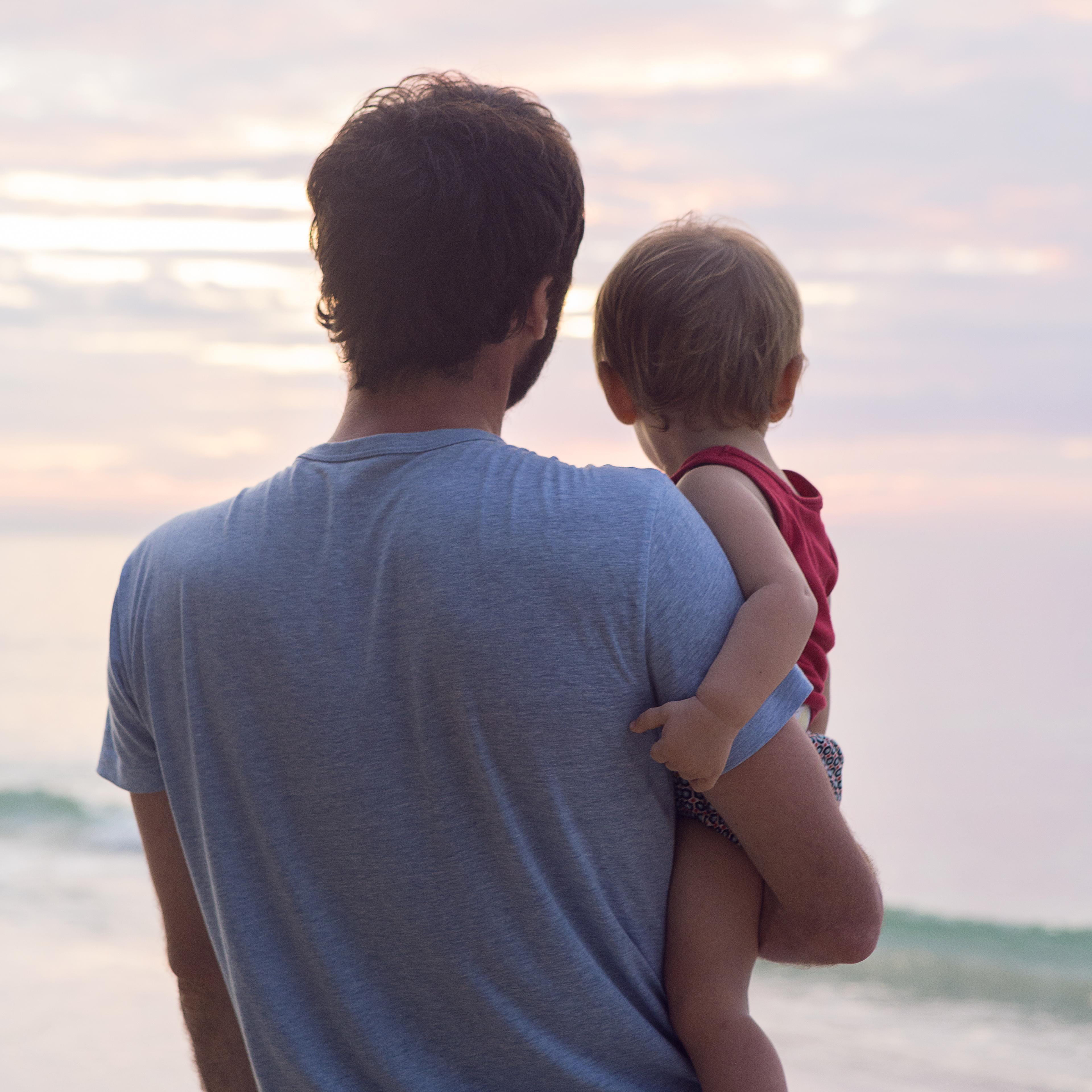 father-holding-baby-beach