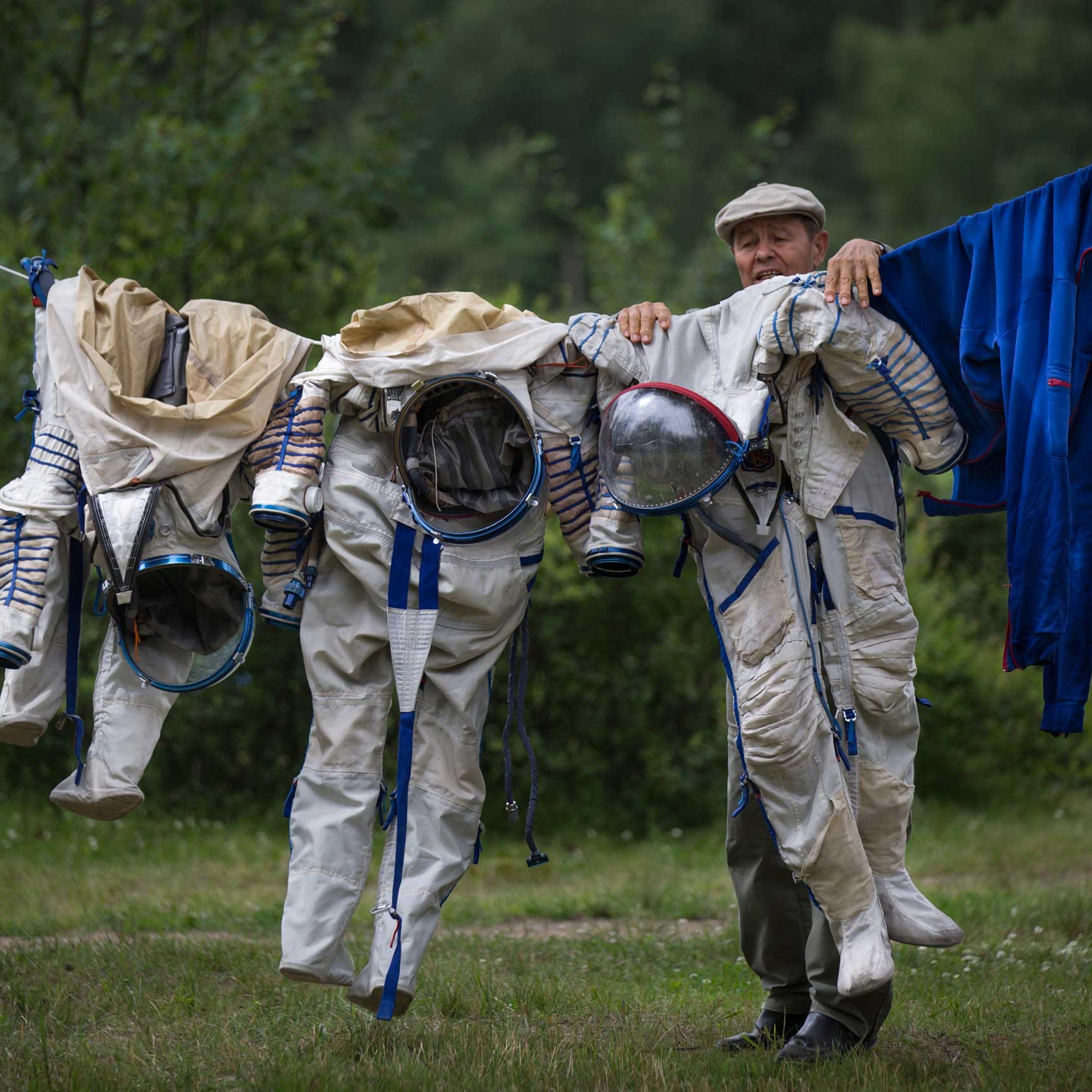 An employee of the Russian Space Training Center hangs space suits out to dry, July 2, 2014.