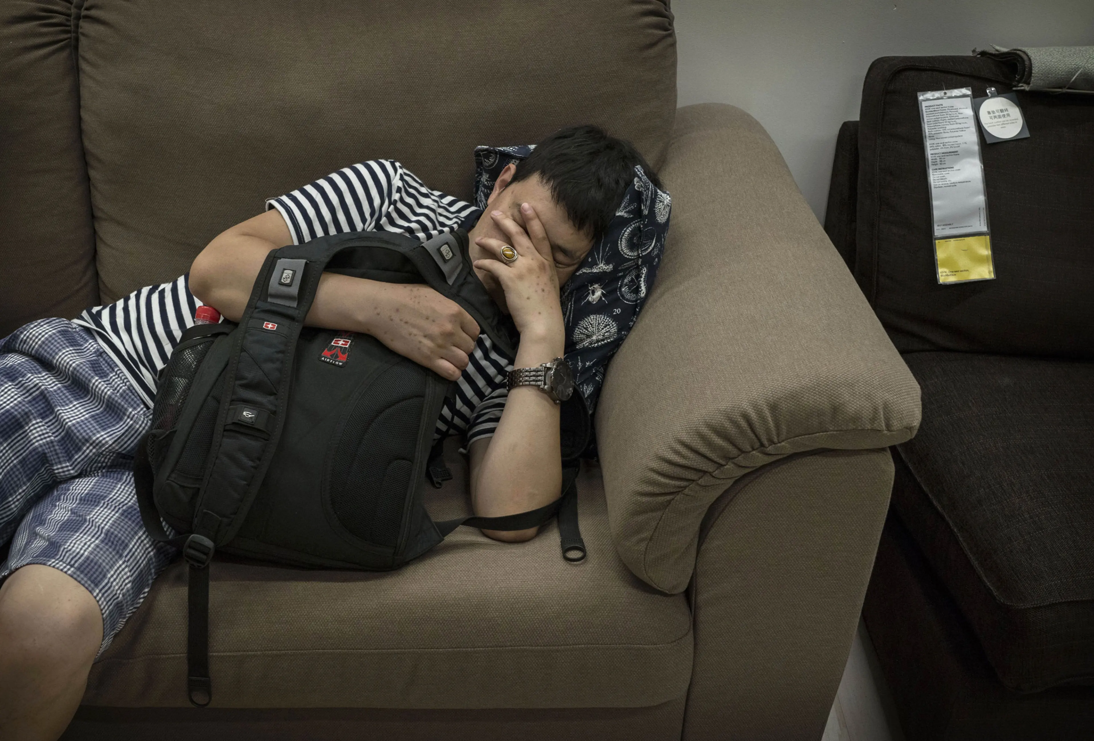 A shopper sleeps on a sofa in the showroom of the IKEA store on July 6, 2014 in Beijing.