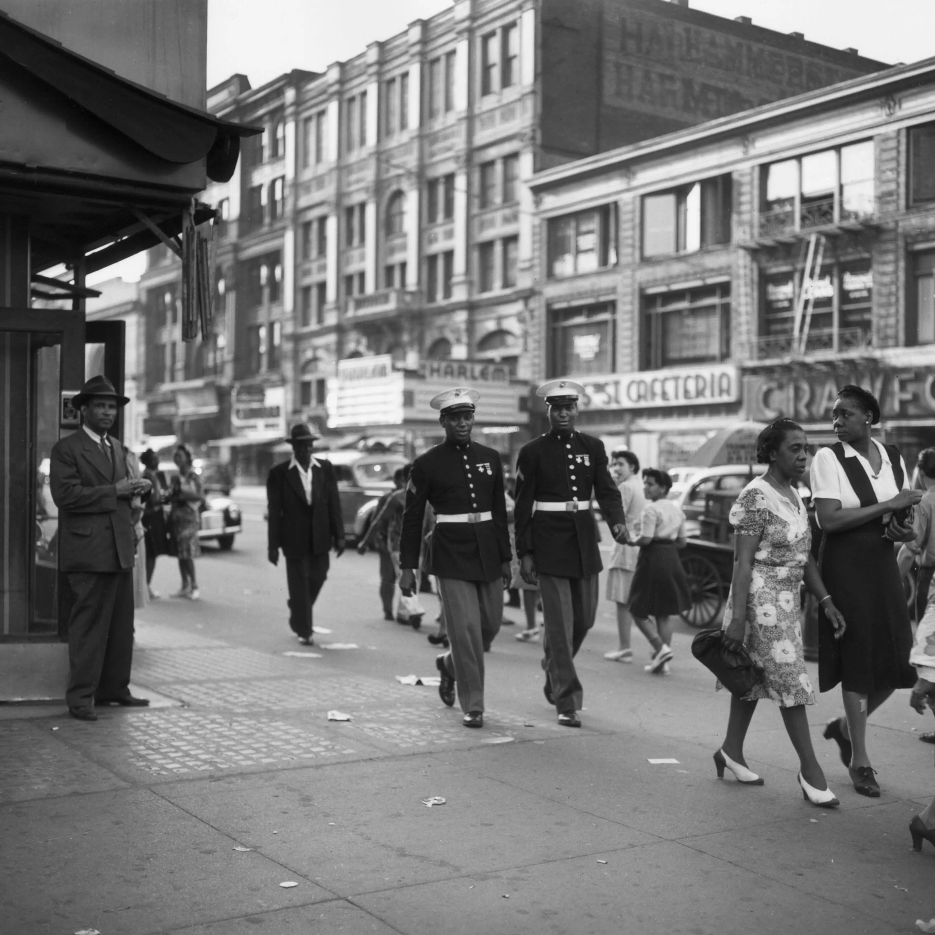 Two African-American Marines walk down a street in Harlem, New York City, in June 1943.
