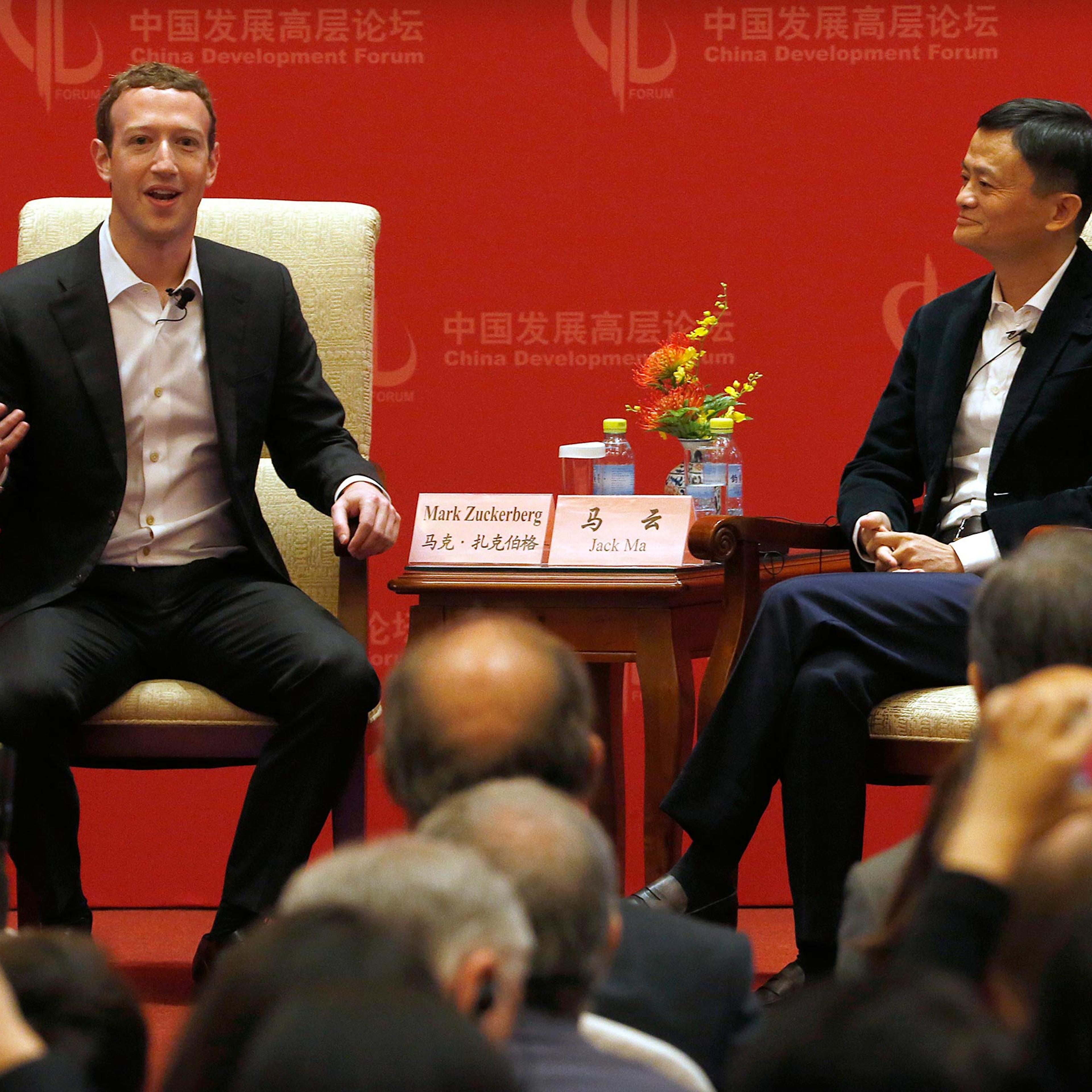 Facebook CEO Mark Zuckerberg speaks as Jack Ma, executive chairman of the Alibaba Group, listens during a panel discussion held as part of the China Development Forum at the Diaoyutai State Guesthouse in Beijing, China, March 19, 2016.