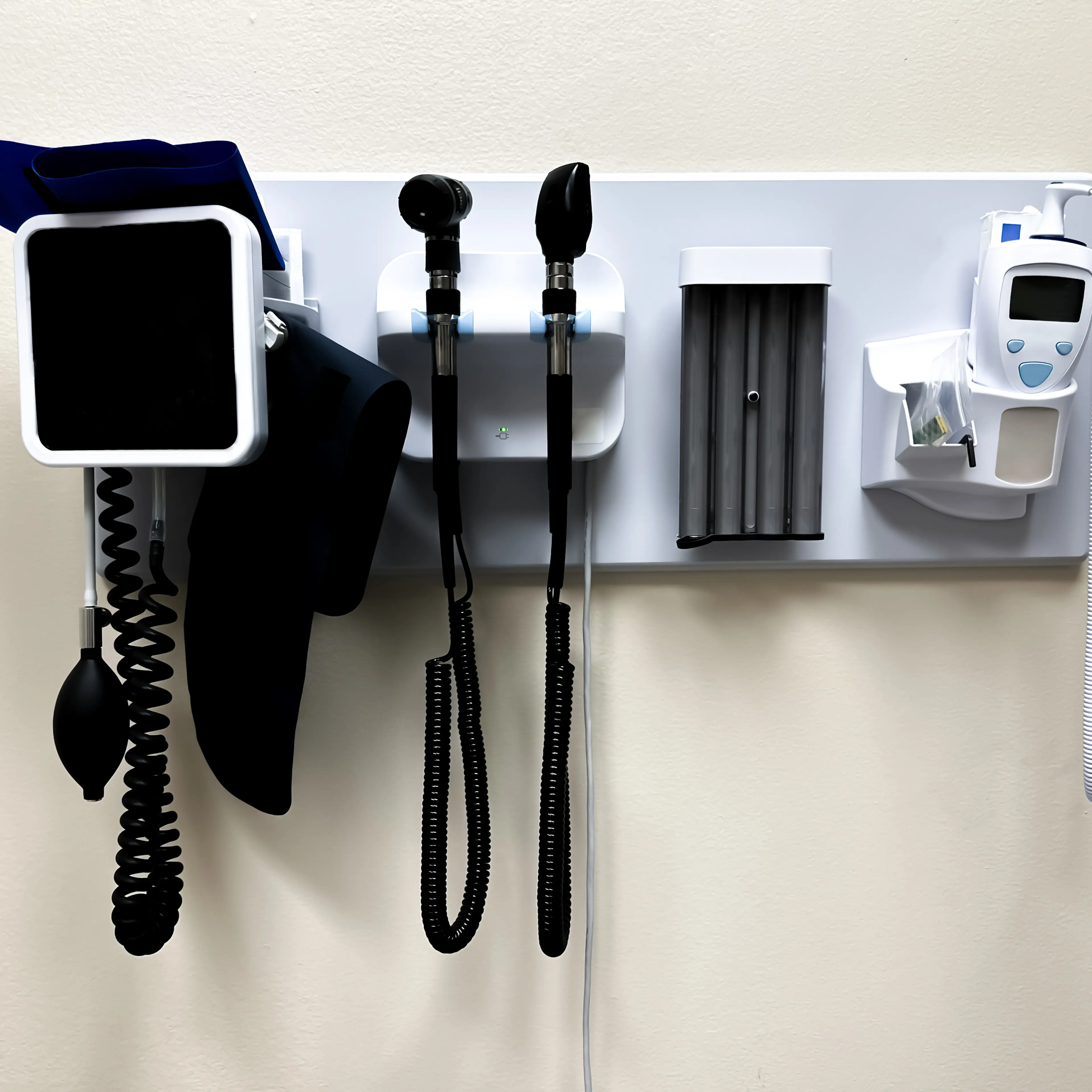 wall-mounted panel of medical diagnostic equipment in standard patient examination room