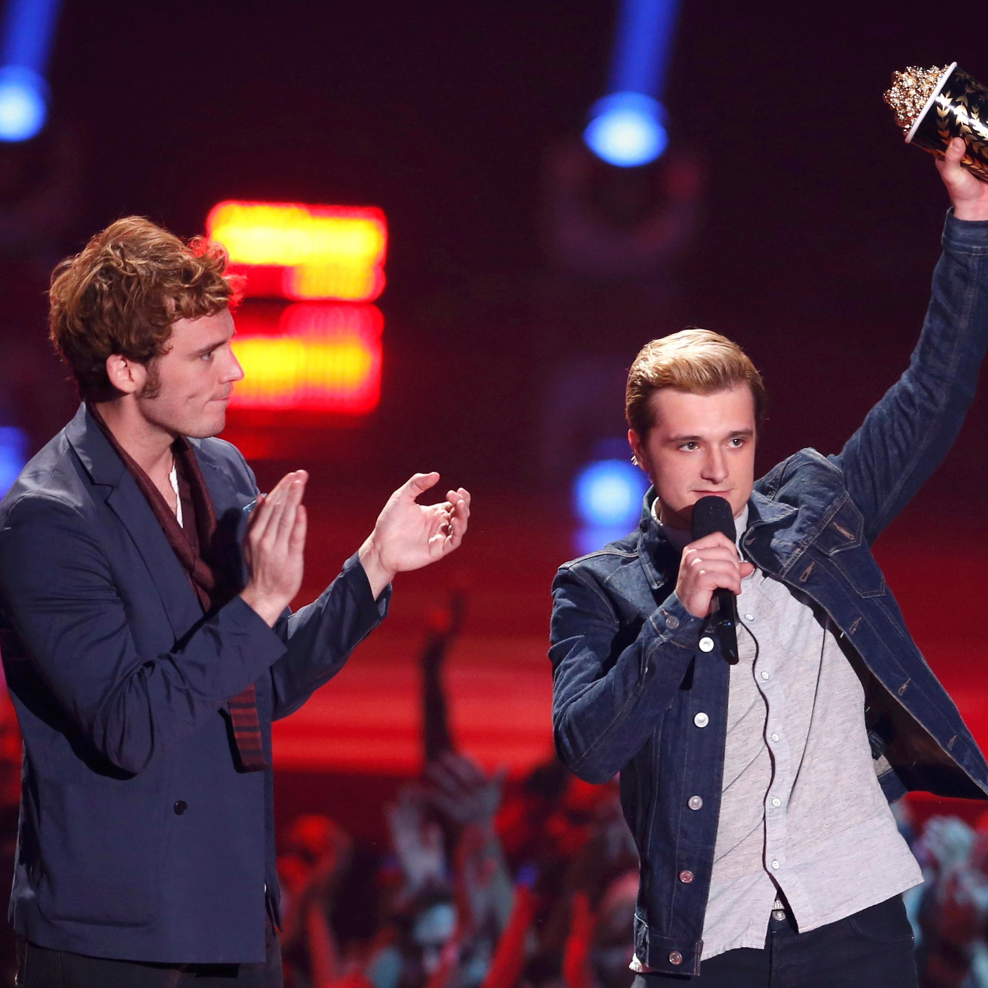 From left: Sam Claflin and Josh Hutcherson accept the award for Best Movie of the Year for "The Hunger Games: Catching Fire" at the 2014 MTV Movie Awards in Los Angeles, on April 13, 2014.