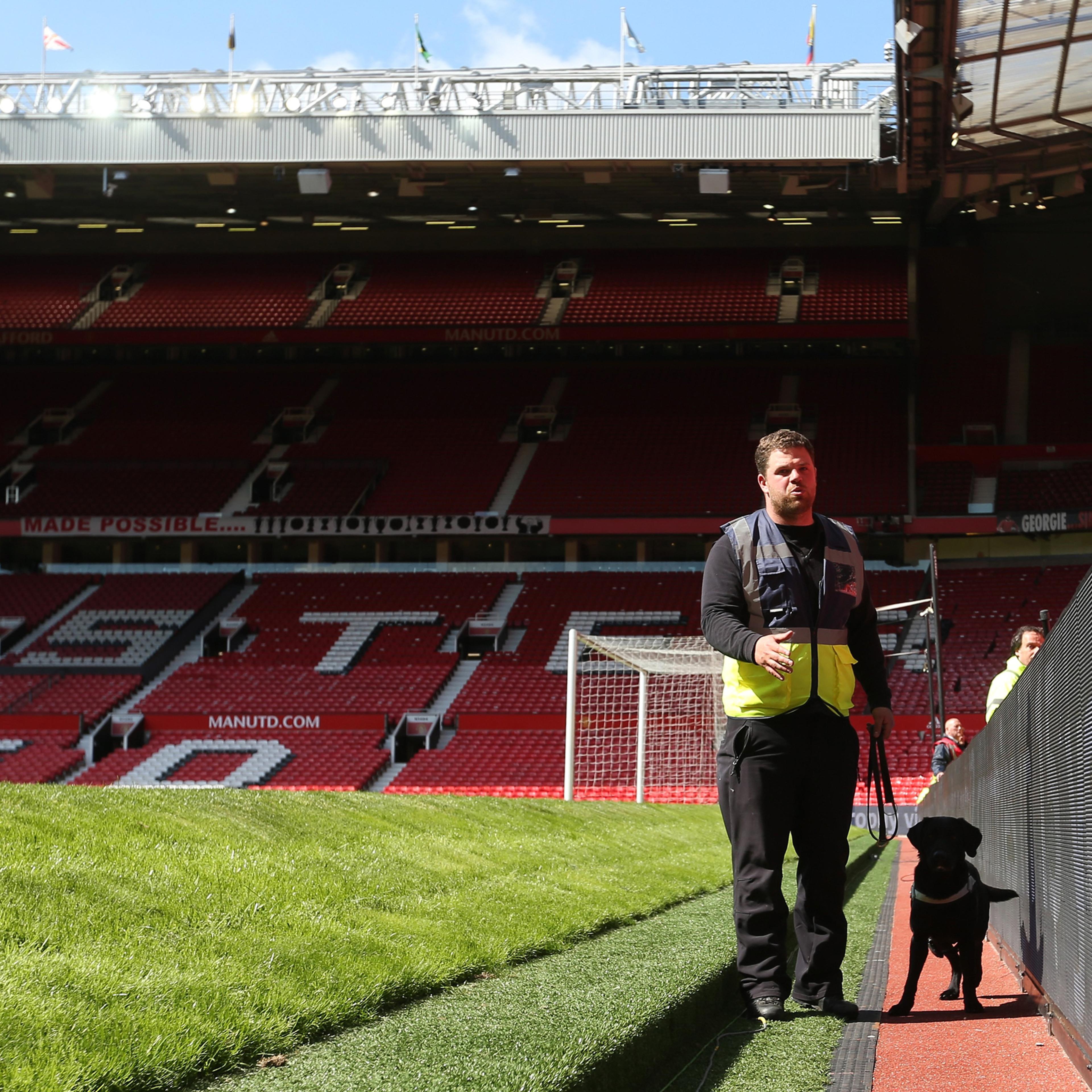 MANCHESTER, UNITED KINGDOM - MAY 15: A sniffer dog patrols pitchside as the match is abandoned with fans evacuated from the ground prior to the Barclays Premier League match between Manchester United and AFC Bournemouth at Old Trafford on May 15, 2016 in