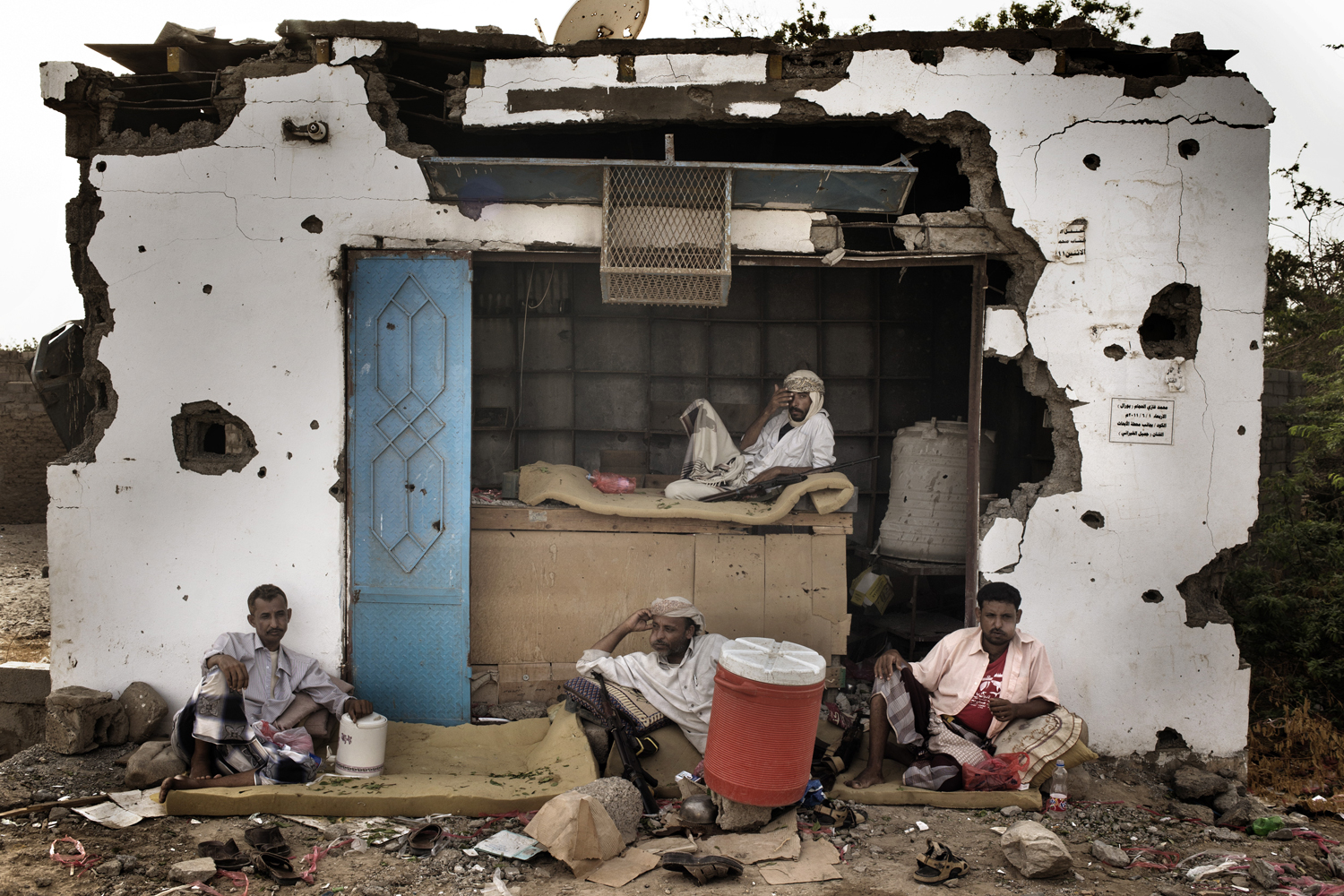 <em>The following photographs were taken in July 2012</em><br>
A member of the 'Popular Committee' in Hajjar takes a mid-afternoon break to chew "qat," a mildly narcotic leaf favored by Yemenis. 