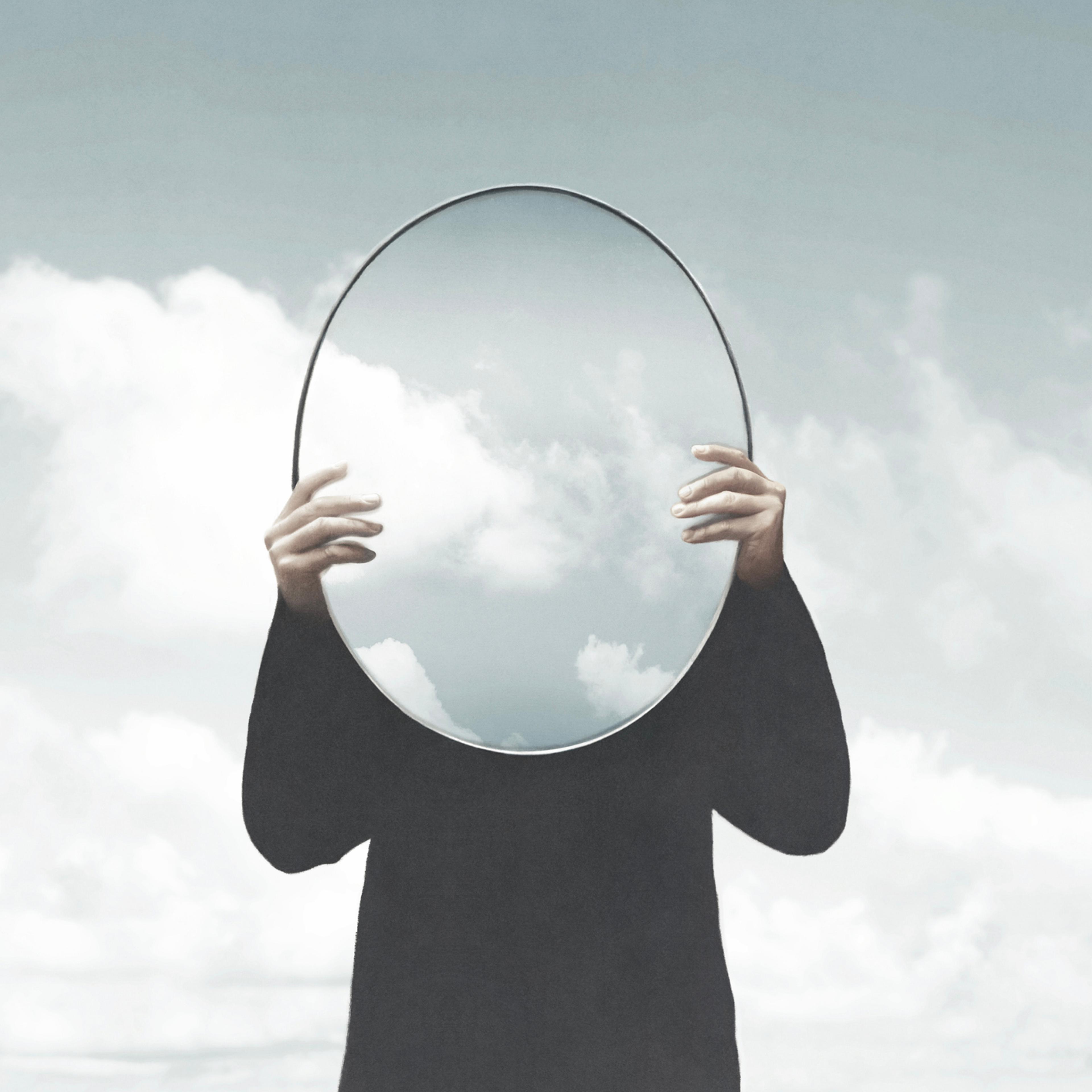 Illustration of woman in black holding a surreal mirror among clouds, surreal abstract concept