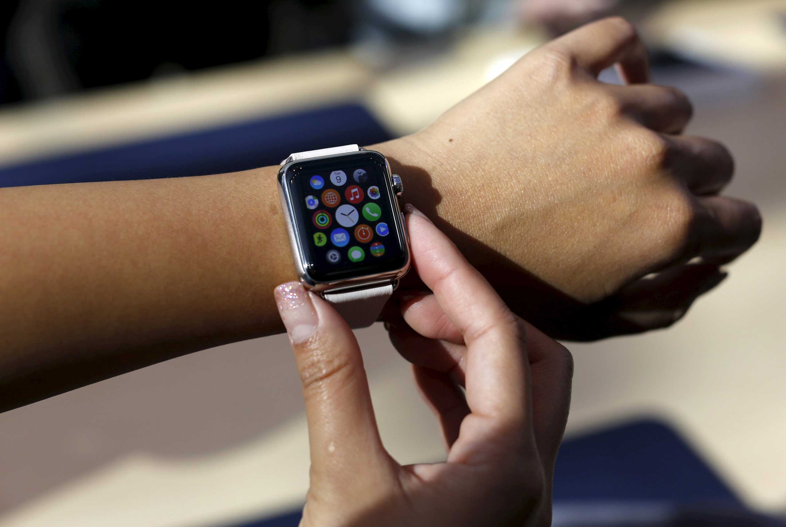 A customer tries on an Apple Watch in Palo Alto, Calif. on April 10, 2015.