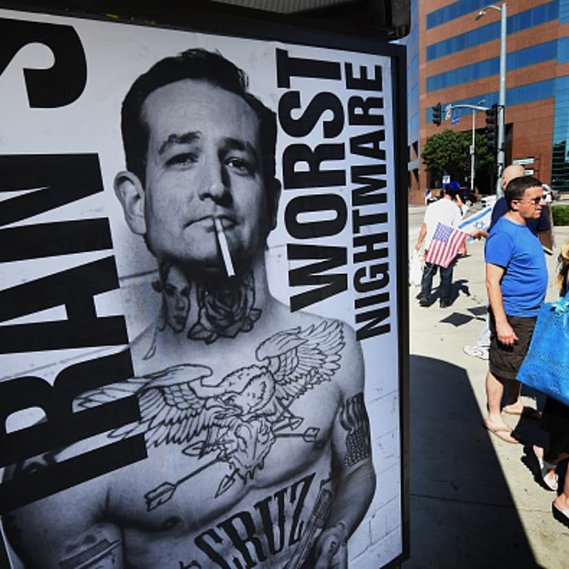 People walk past posters supporting politician Ted Cruz put up by the 'StandWithUs' group during a rally calling for the rejection of the proposed Iran nuclear deal outside the Federal Building in Los Angeles, California on July 26, 2015.