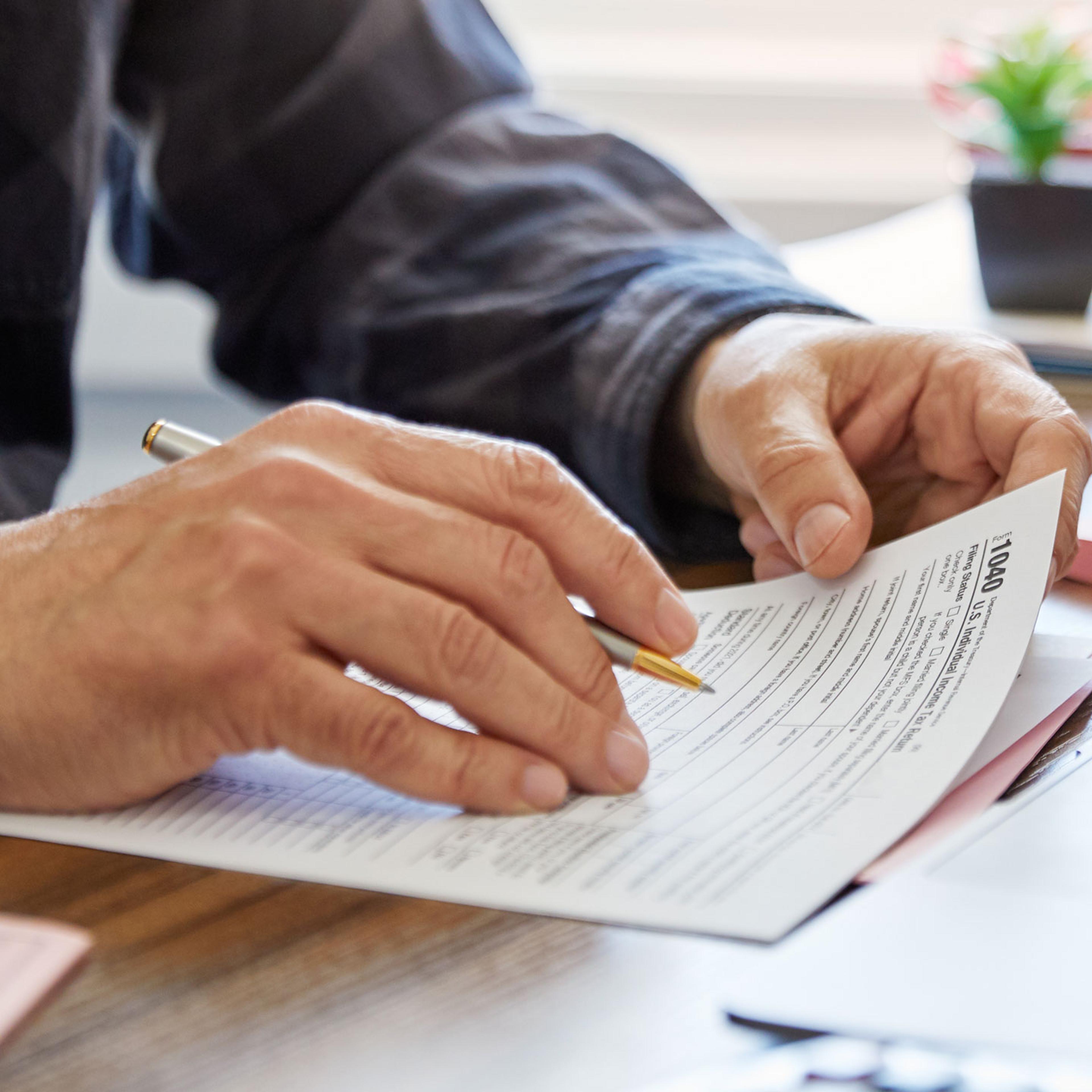 Close-up of a man holding a tax form