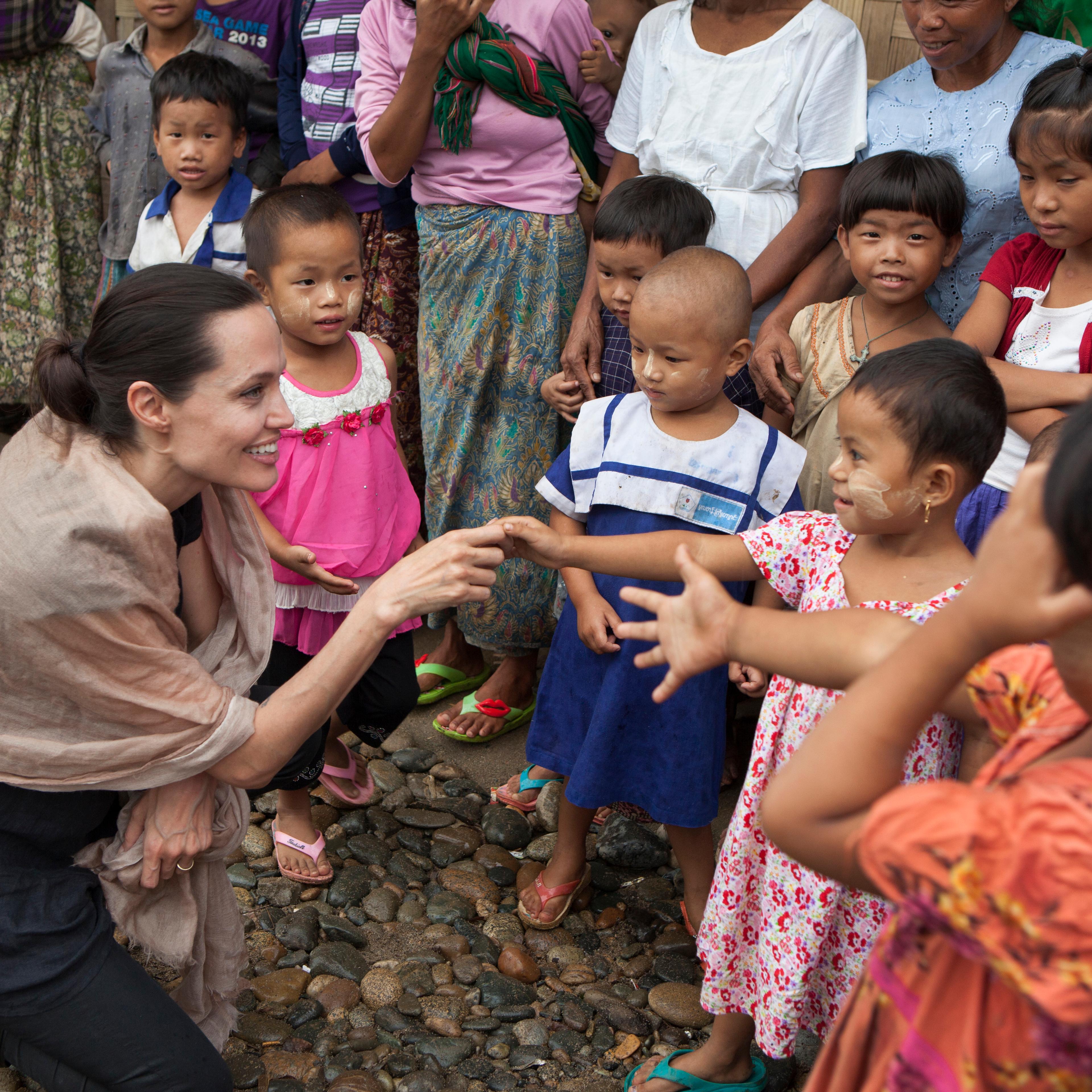 In this handout photo provided by the Maddox Jolie-Pitt Foundation, actress and activist Angelina Jolie Pitt meets children during a visit to Ja Mai Kaung Baptist refugee camp on July 30, 2015 in Myitkyina, Burna.