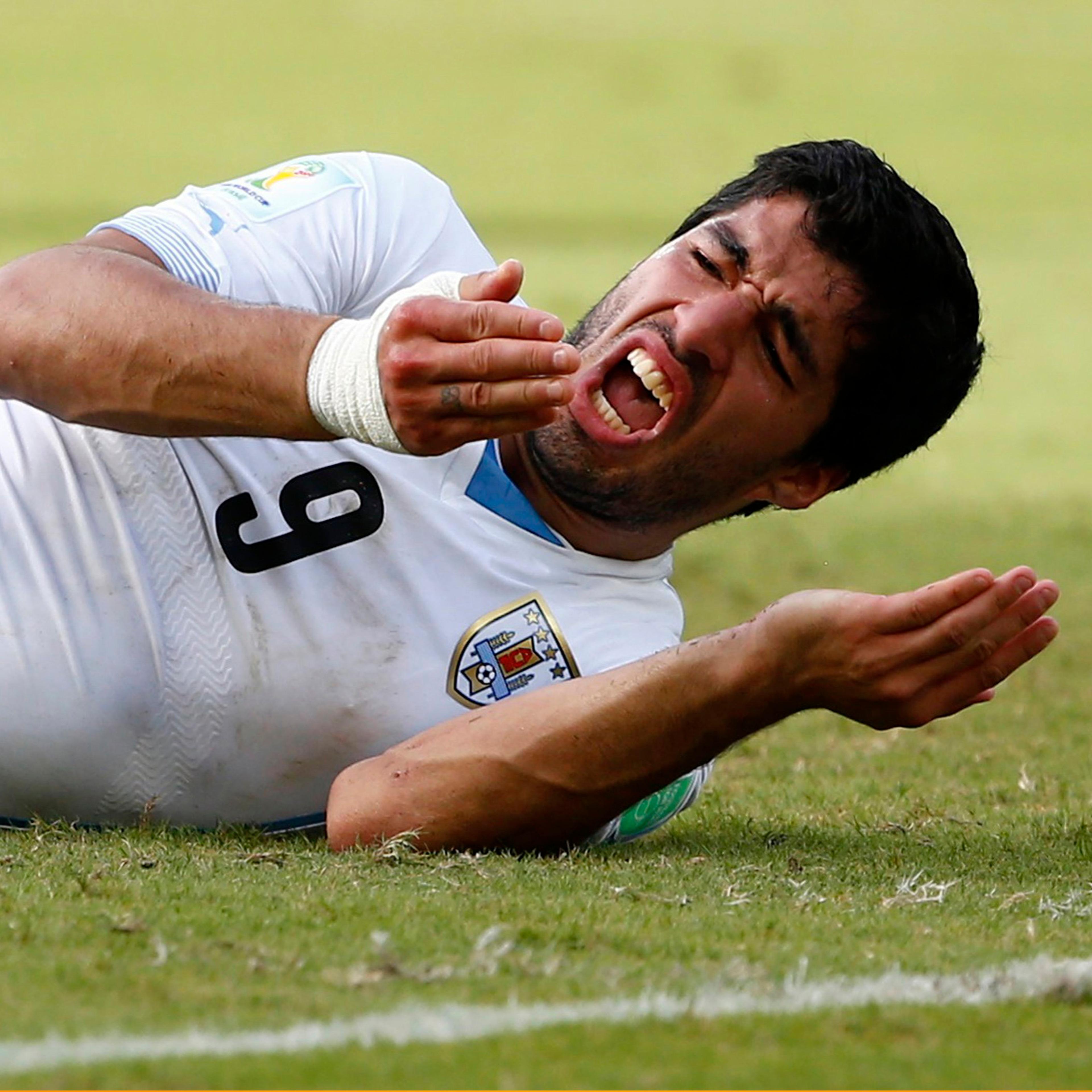 Uruguay's Luis Suarez reacts after clashing with Italy's Giorgio Chiellini during their 2014 World Cup Group D soccer match at the Dunas arena in Natal, Brazil on June 24, 2014.