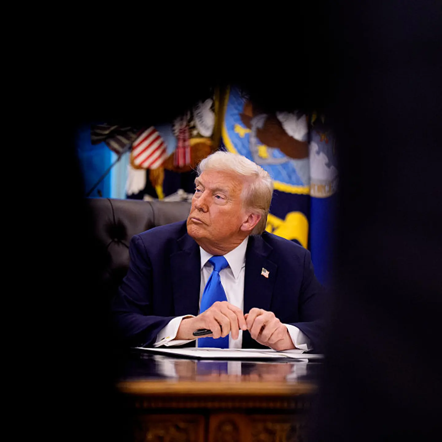 President Donald Trump sits at the Resolute desk after signing an executive order in the Oval Office at the White House in Washington, D.C., on September 19, 2025.