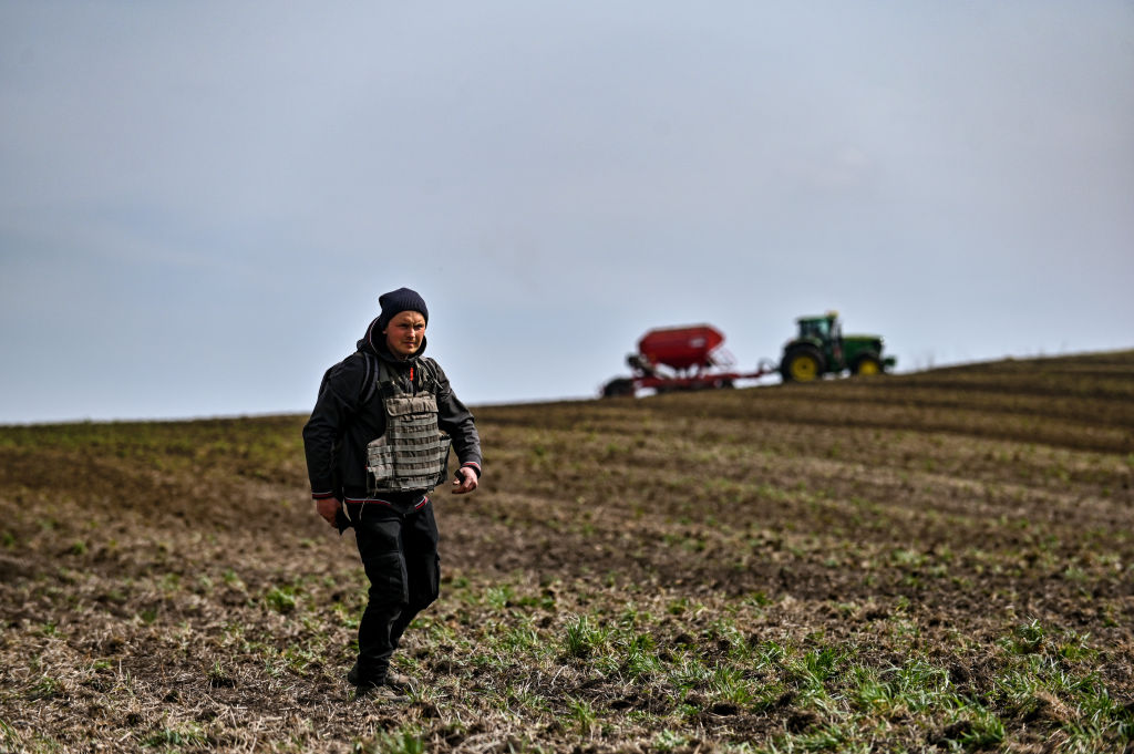 A farmer wears a bulletproof vest during crop sowing which takes place 30 km from the front line, Zaporizhzhia Region, southeastern Ukraine.