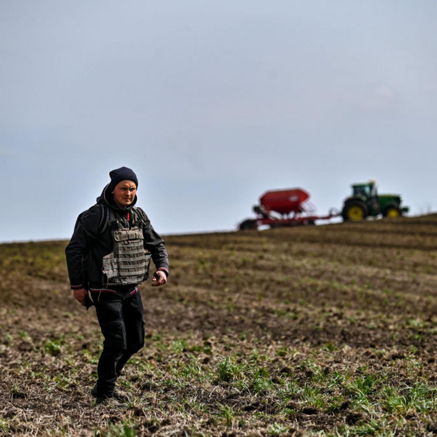 A farmer wears a bulletproof vest during crop sowing which takes place 30 km from the front line, Zaporizhzhia Region, southeastern Ukraine.