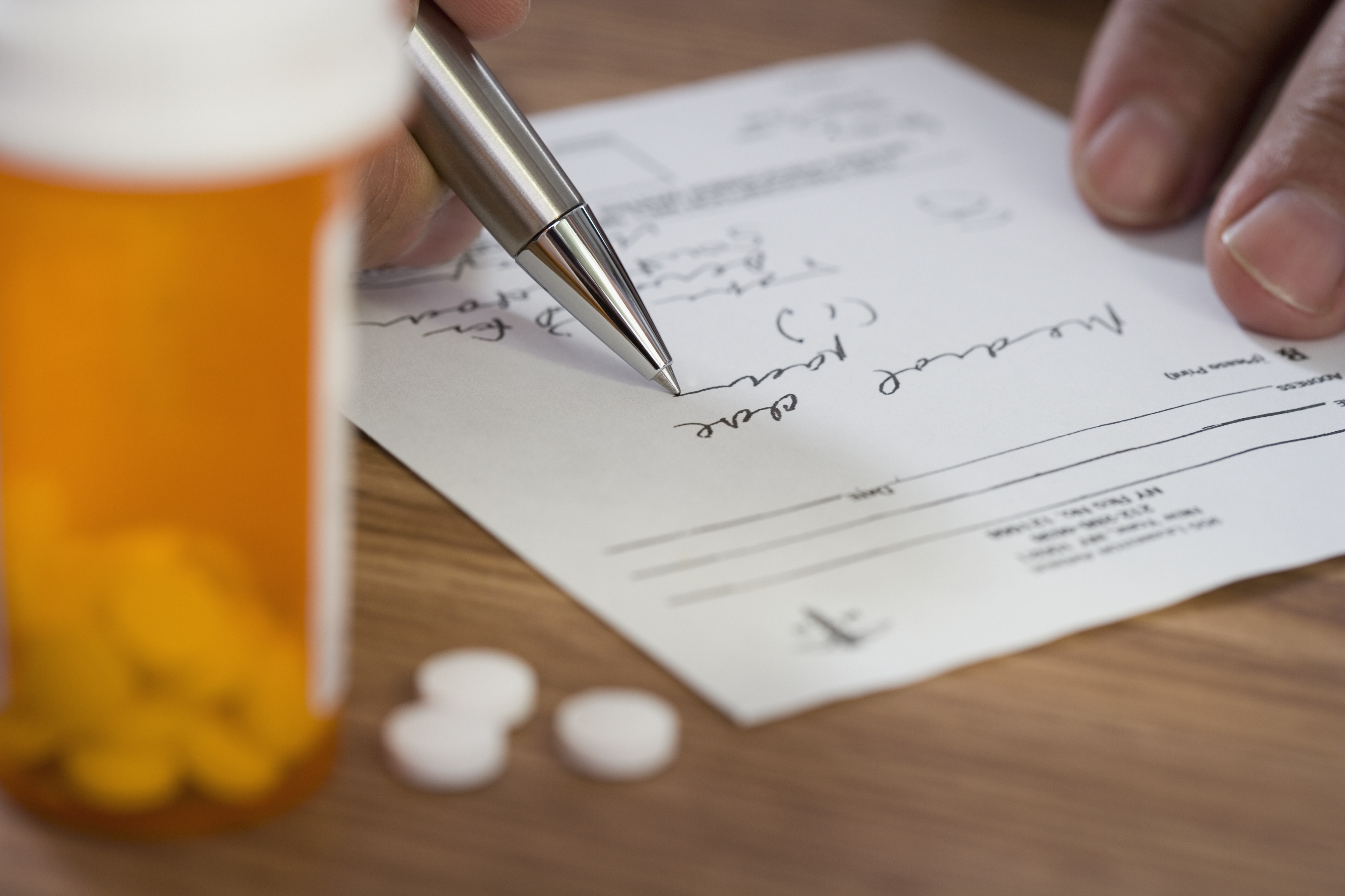 Close up of man filling out prescription