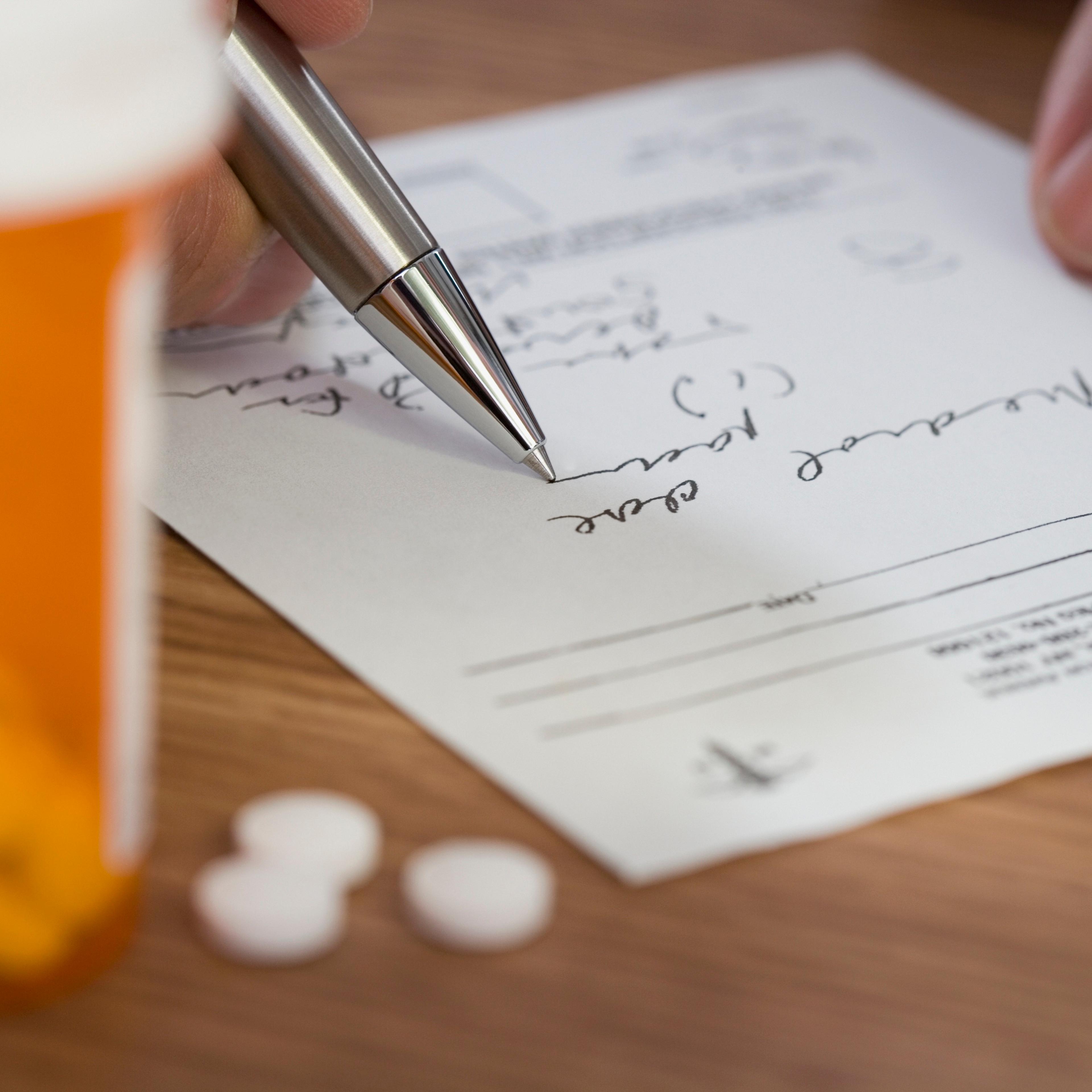 Close up of man filling out prescription
