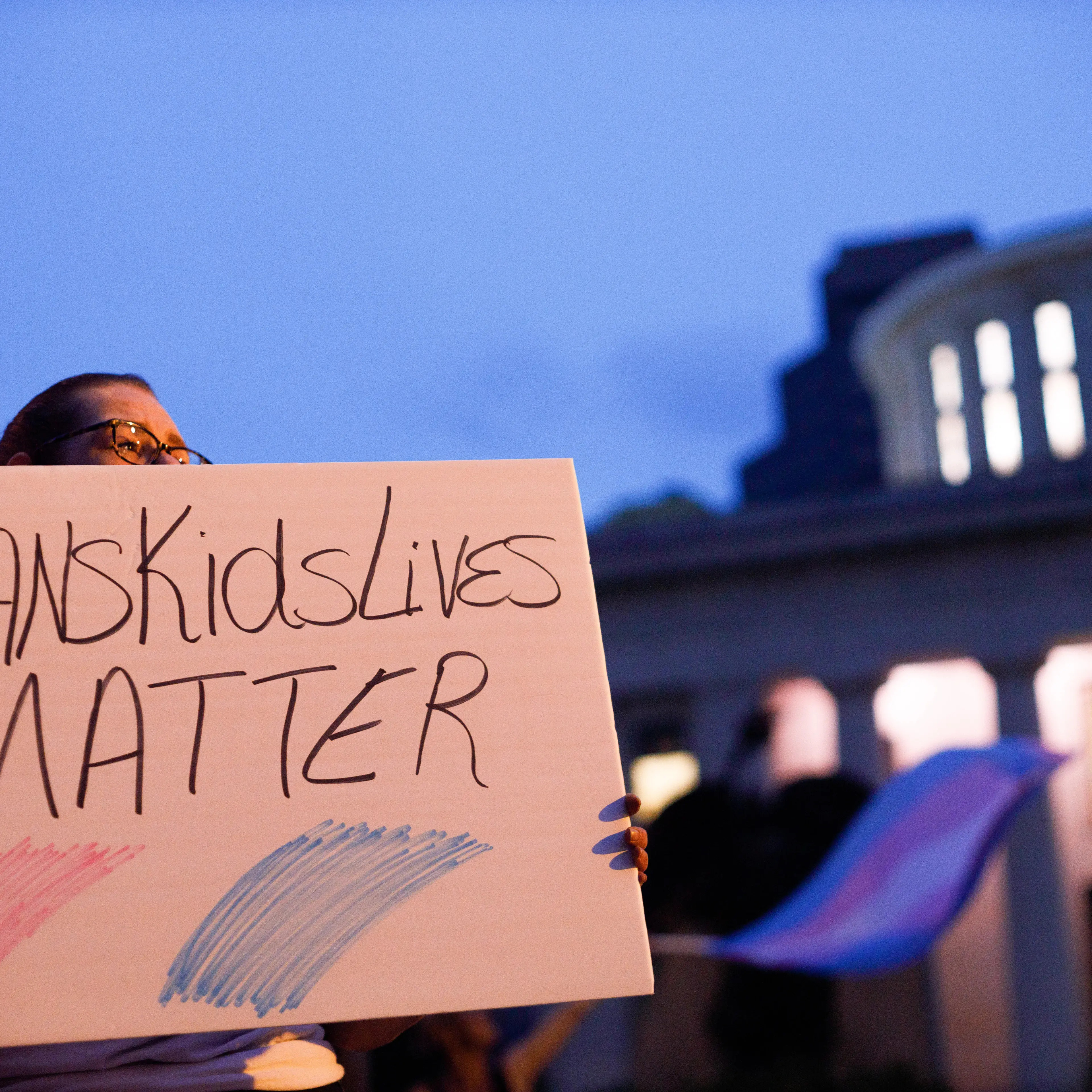Transgender rights advocate holds a sign
