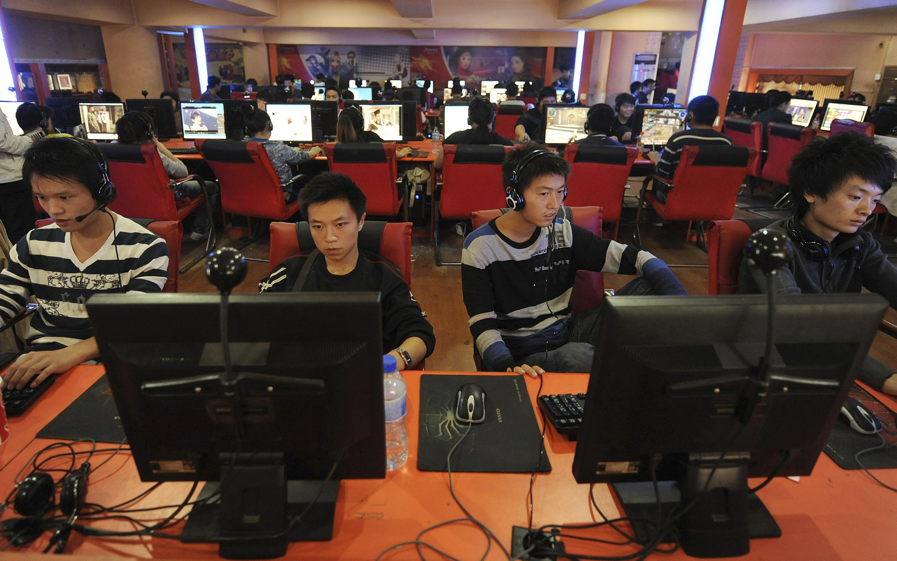 People use computers at an Internet cafe in Hefei
